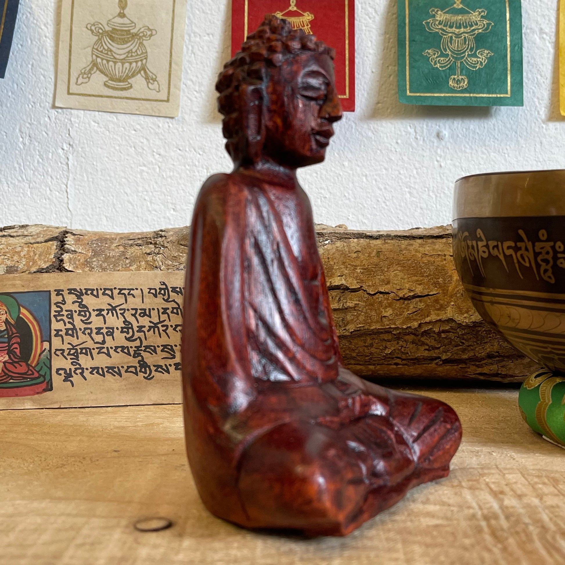 A stunning, hand carved wooden figure of Buddha, the founder of Buddhism. Our Buddhas have been hand carved in Bali using traditional methods of the island. Each carver has taken years perfecting his or her skill to be able to create work to this standard.  Hand carved wooden sitting Buddha  Made from Raintree wood in Bali