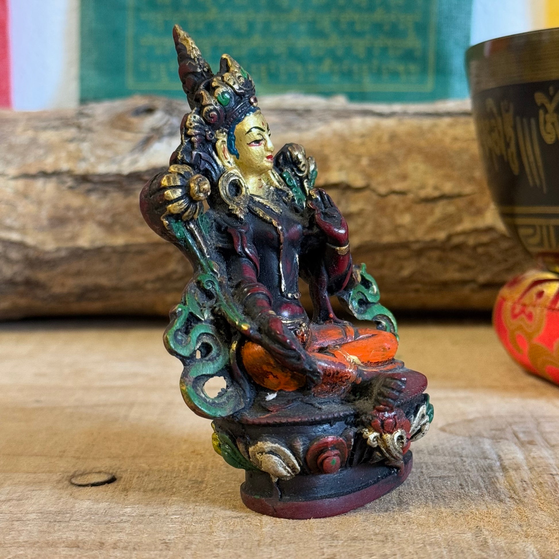 "Hand-painted 10 cm Green Tara resin statue with intricate details. Depicts compassion and readiness with protective and giving mudras. Perfect for altars or gifting!"