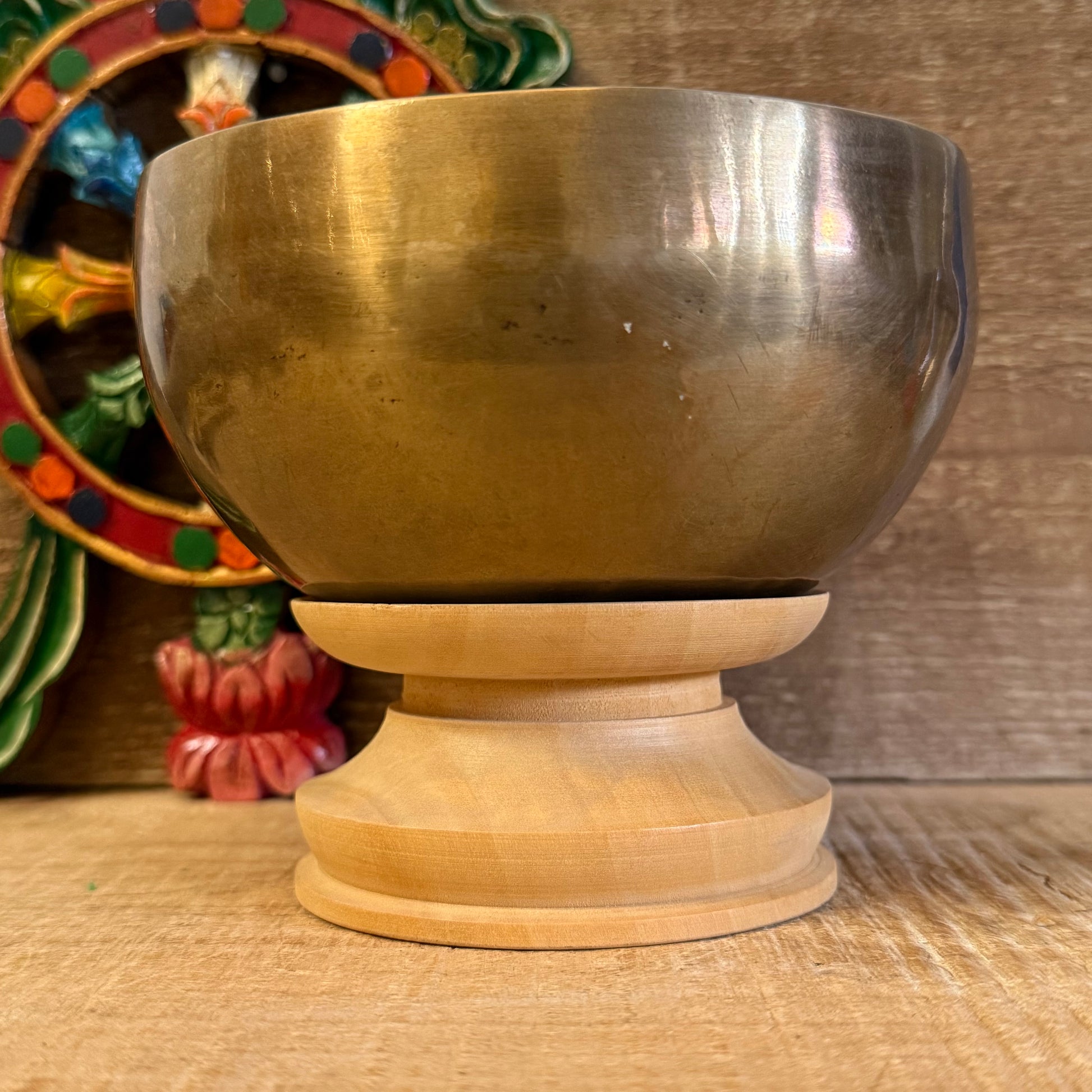 Let your singing bowl rest with dignity and balance on this simple yet elegant Singing Bowl Stand. Designed to support and display your sacred bowl without distraction, it brings harmony to any altar, meditation space, or shop setting.

Whether you're a practitioner, collector, or storekeeper, this understated stand highlights the beauty of your bowl while providing a stable and respectful base. Crafted in Nepal, it reflects the quiet care that accompanies traditional Buddhist practice.