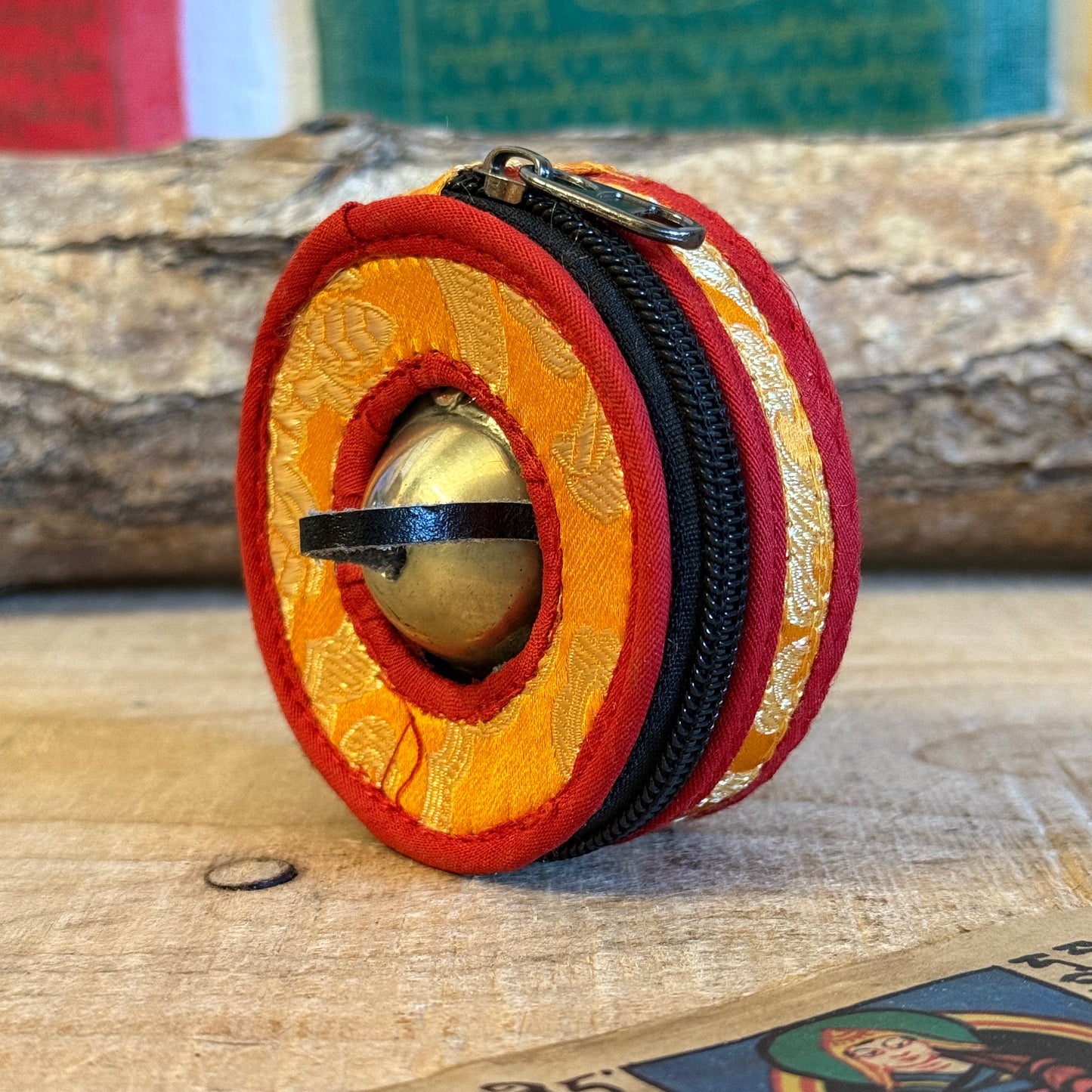 Protect your tingsha set with a beautiful brocade tingsha container.
This bag is made of orange/red&nbsp;cotton, lined on the inside and has a&nbsp;cotton&nbsp;in-between ring. Beautiful&nbsp;finish with a zipper.