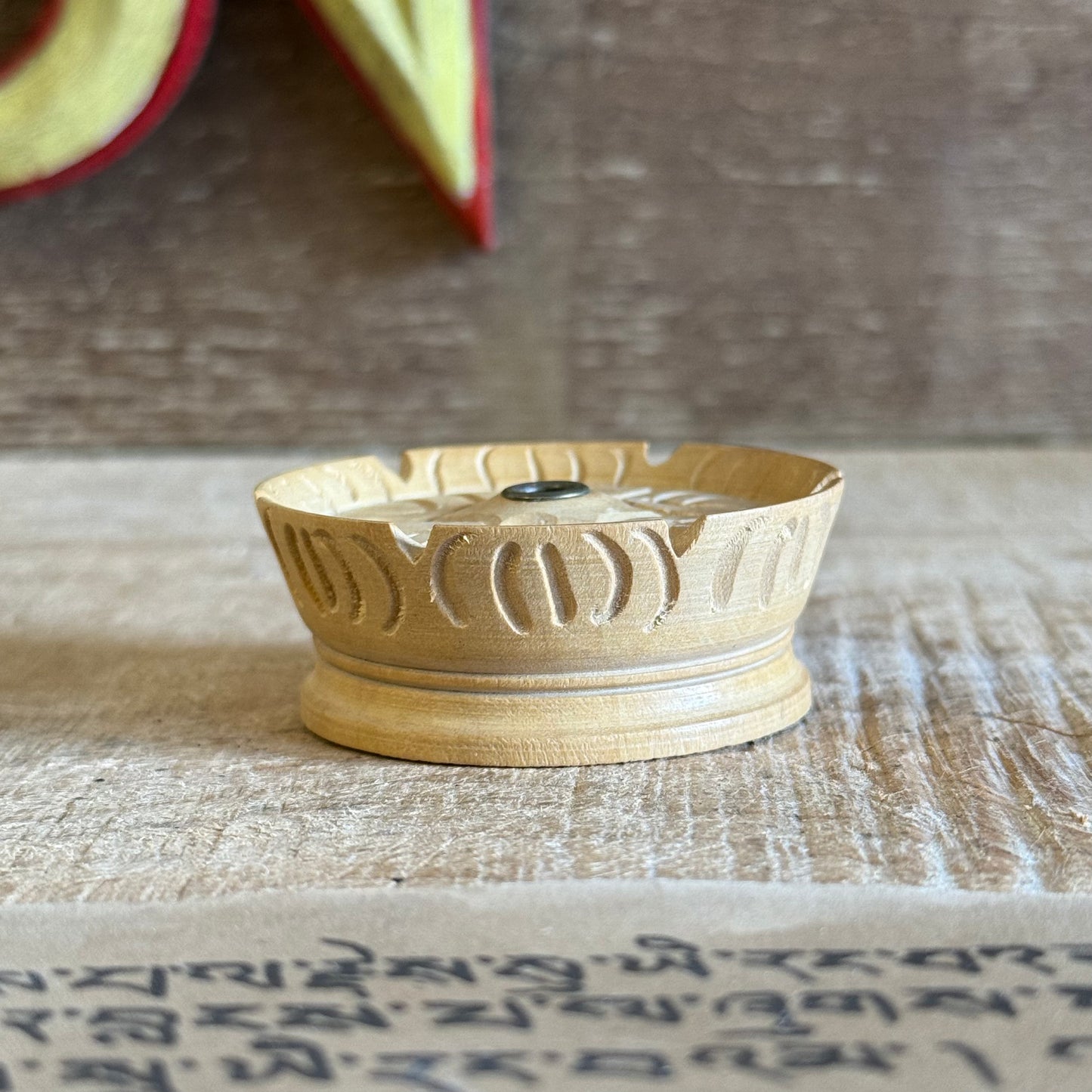 This beloved Lotus Tibetan Incense Holder is a simple yet sacred companion for your incense practice. Hand-carved from a single piece of soft yellow wood in Nepal, each piece carries the gentle energy of mindful craftsmanship and Buddhist symbolism.

The lotus, carved into its form, is a profound symbol of spiritual awakening — rising from the mud to bloom in stillness and clarity. Its wide, rounded base is designed to safely catch falling ash, making it both beautiful and practical.