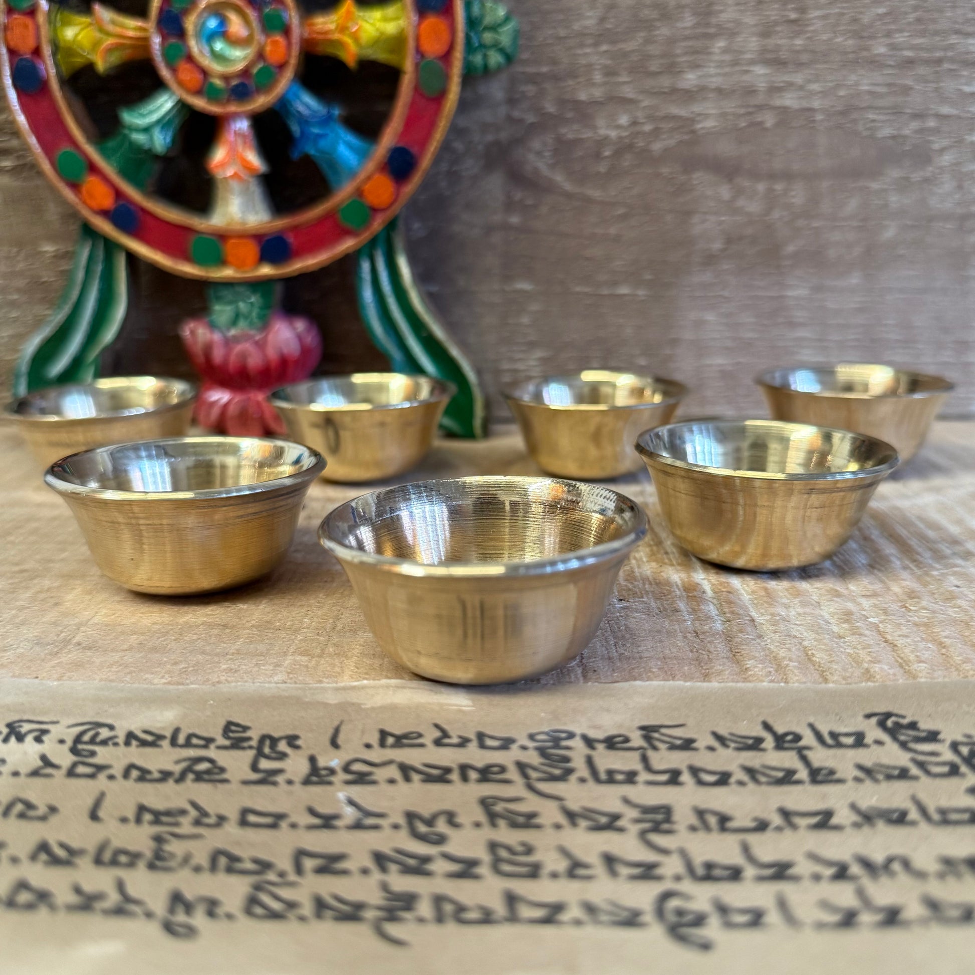 These Small Brass Offering Bowls are used in the sacred practice of making offerings to the Buddhas and Bodhisattvas. A complete set of seven symbolizes the perfection of generosity and is arranged on altars in temples, shrines, or home meditation spaces.

Traditionally, each bowl is filled with substances such as water, incense, perfumed oil, food, flowers, or light—expressing a pure heart and the wish to cultivate virtue. Laying out these offerings is a daily act of devotion, mindfulness, and humility.