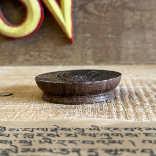 Hand-carved with reverence and skill, this Lotus Flower Incense Holder is made from a single piece of rich, dark Nepalese wood. Its elegant lotus flower design symbolizes the blossoming of inner peace through mindful living.