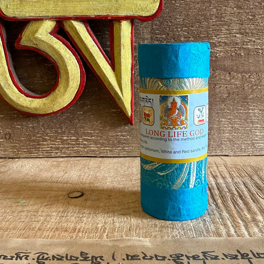Blue cylindrical container with a label on a wooden surface