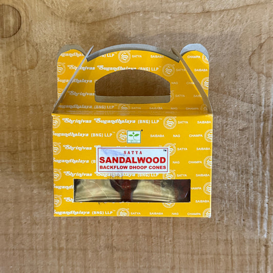 Satya Sandalwood Backflow Incense Cones creating cascading smoke for meditation