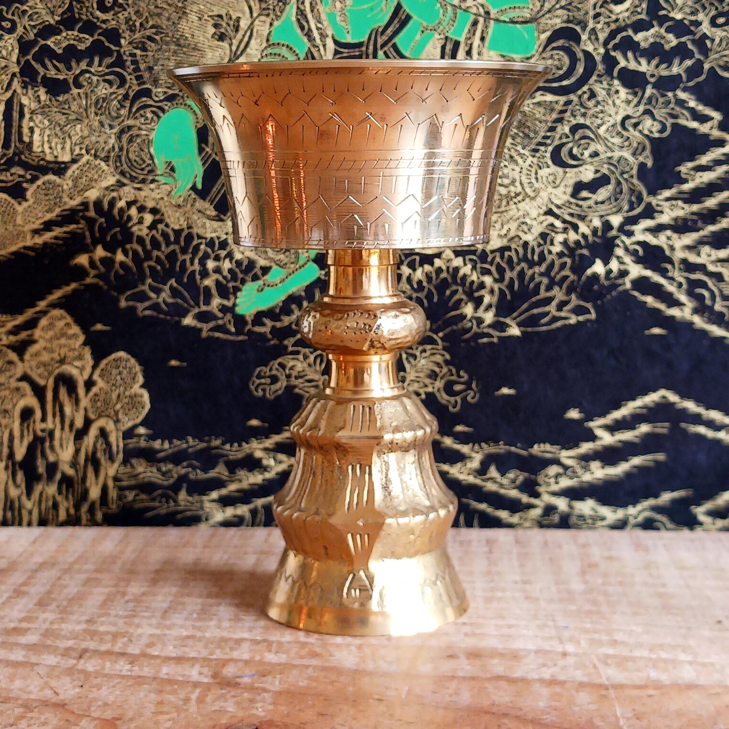 Made from durable brass, the butter lamp emits a warm, soothing glow—ideal for enhancing meditation, prayer, or altar settings. Its two-piece design features a convenient screw mechanism, making it easy to clean and store. A symbol of devotion and cultural heritage, this lamp adds authenticity and serenity to any spiritual practice.