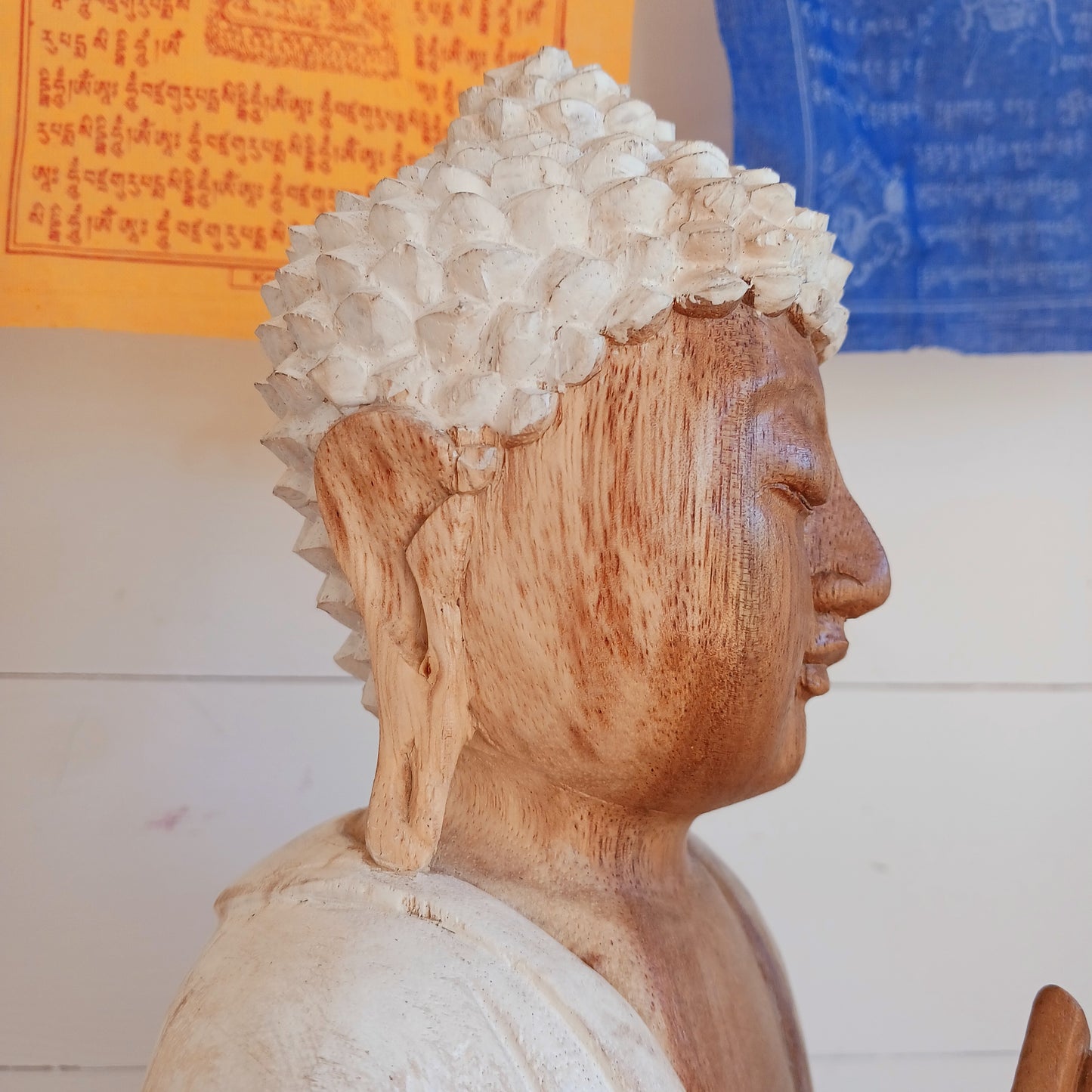 Bring calm, wisdom, and mindful intention into your space with this beautifully serene Teaching Buddha statue, hand-carved from sustainable Suar wood (Albizia Saman), a fast-growing and responsibly cultivated hardwood, finished in whitewash.