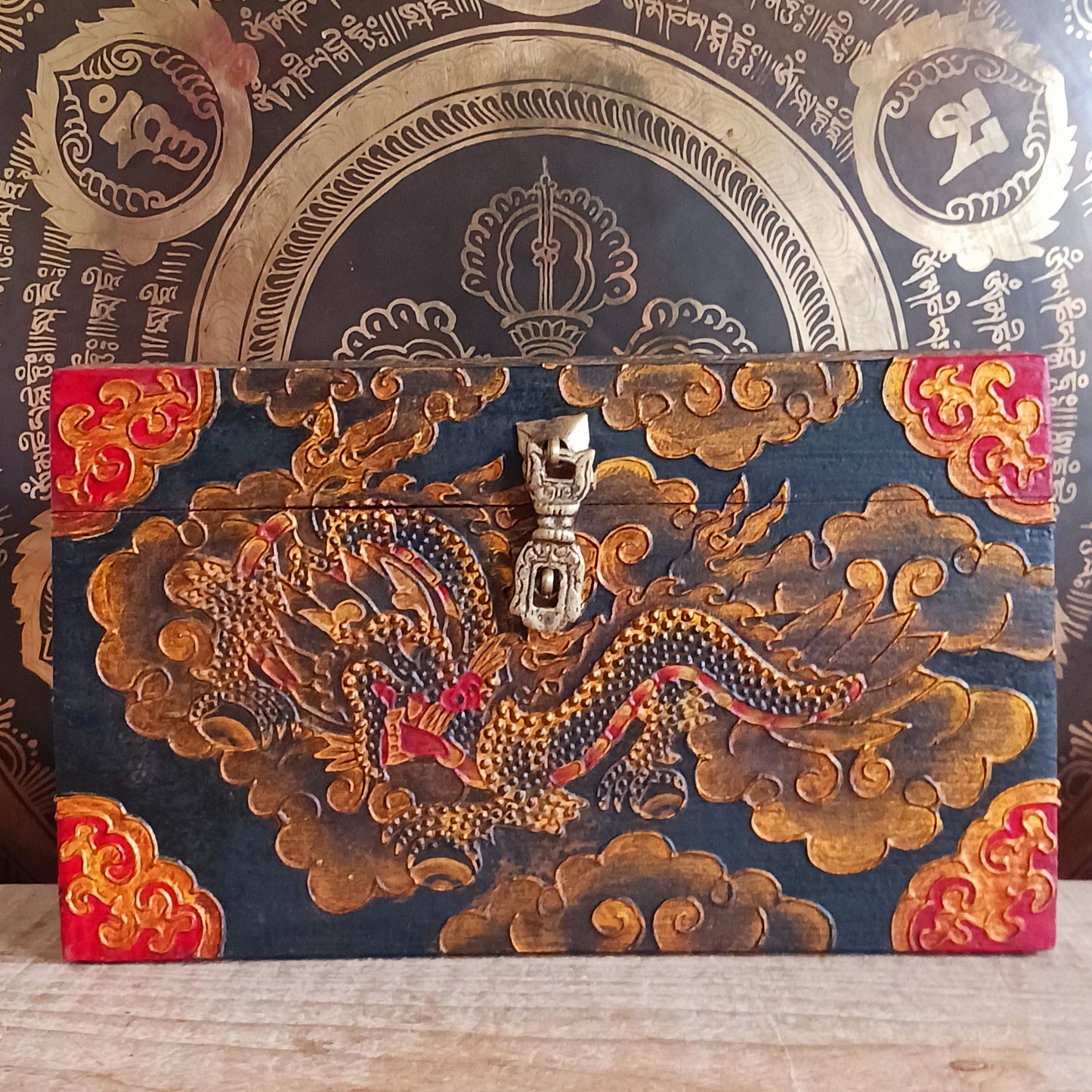 These beautiful hand painted traditional Tibetan treasure box has been carefully handcrafted in Kathmandu, Nepal by a small group of Tibetan artists. The boxes are hand painted with a dragon motif on the front, Yin Yang and Eternal Knot designs on the top in black, gold and red paint.