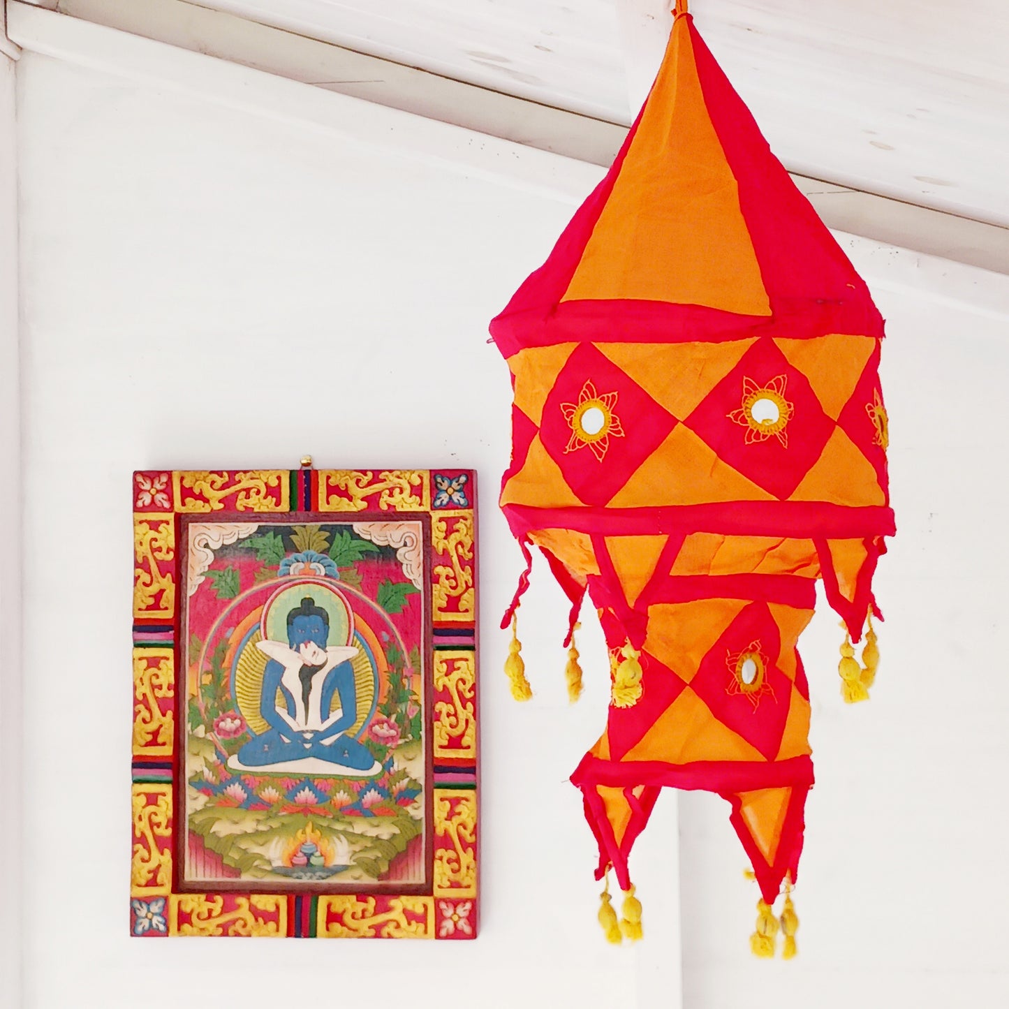 Bring colour, culture, and warmth into your space with this traditional handmade cotton Jhumar lampshade from Nepal. Carefully crafted by skilled artisans, each lampshade is made from vibrant cotton fabric and decorated with beautiful embroidered synthetic mirrors, creating a unique and eye-catching design.