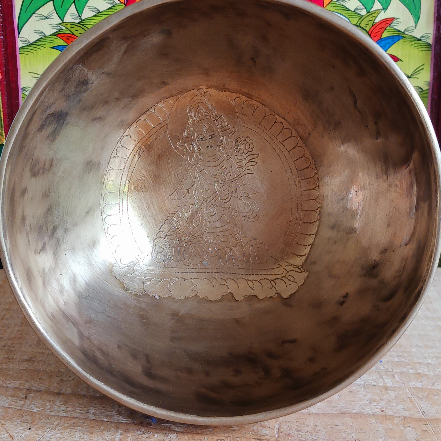 Elevate your spiritual practice with this unique, hand-beaten singing bowl, featuring a stunning Green Tara engraving inside the bowl. Known as the goddess of compassion and action, Green Tara is a powerful symbol in Tibetan Buddhism, bringing calm, protection, and clarity to your space. This bowl produces rich, resonant tones perfect for meditation, sound healing, or sacred decor.