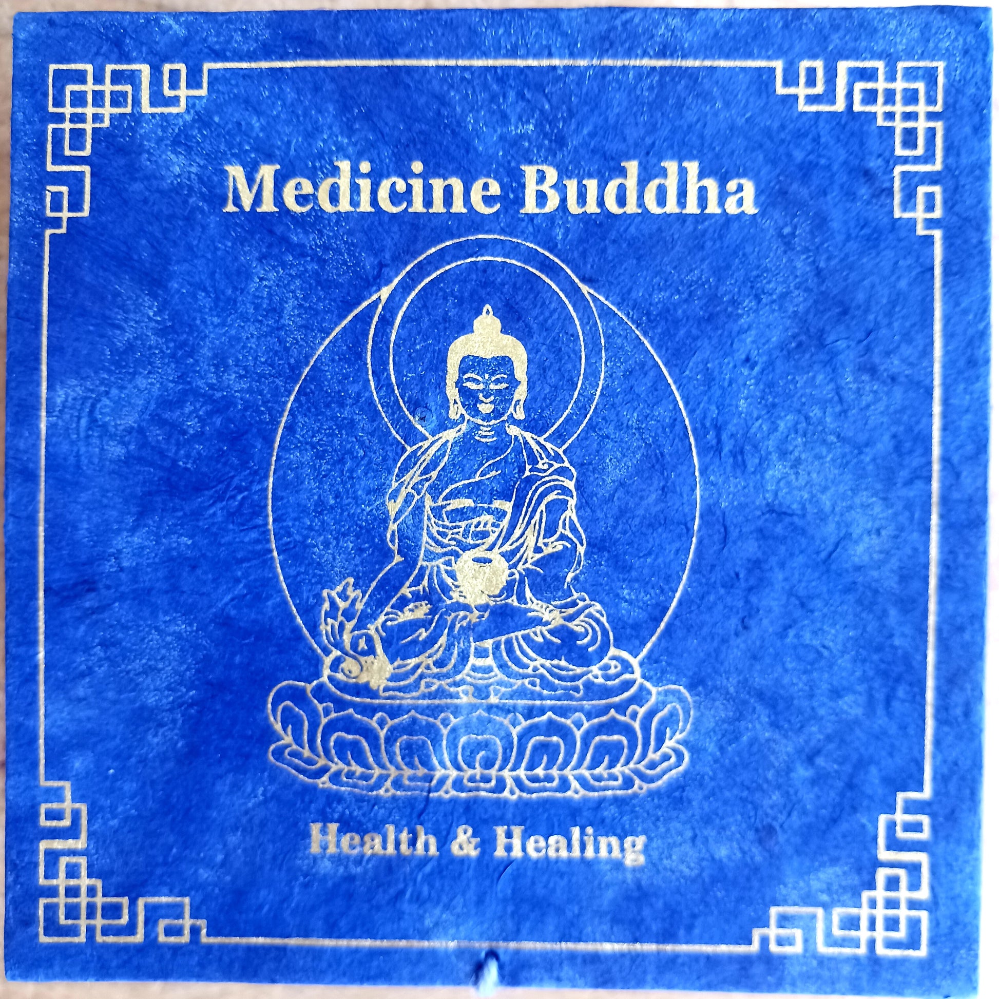 Elevate your practice with a hand-hammered Medicine Buddha singing bowl set, complete with cushion, striker, and symbolic gift box.