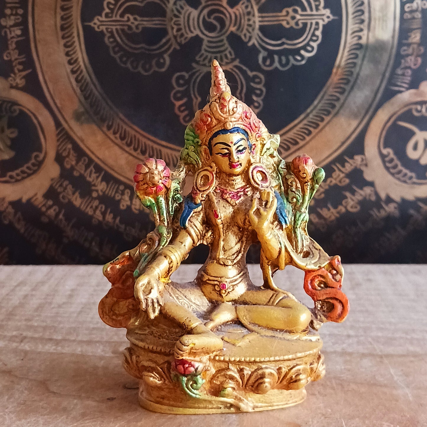 Bring peace, protection, and positive energy into your space with this exquisite Hand-Painted Gold Resin Green Tara Statue. 