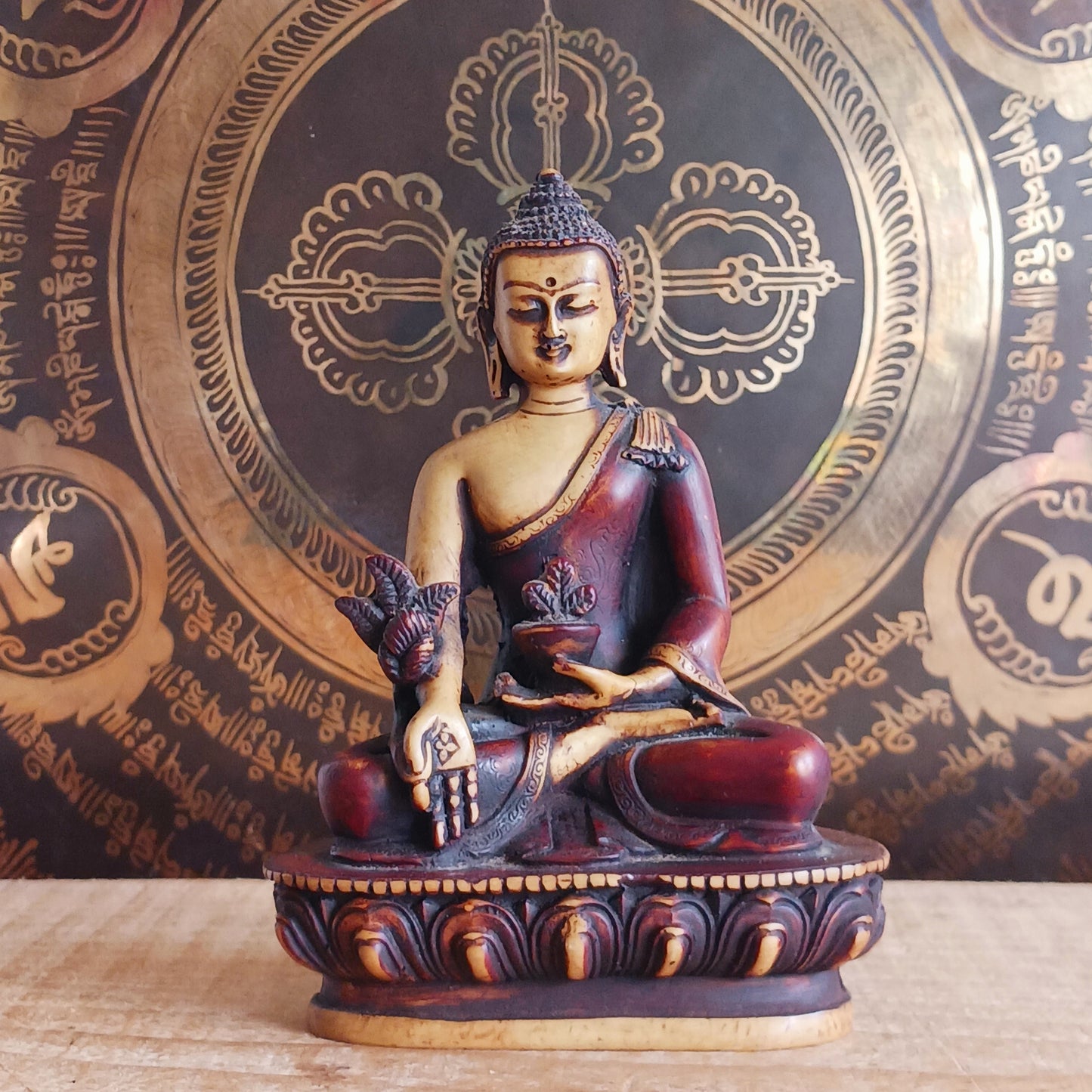 Invite healing, peace, and spiritual protection into your space with this beautifully crafted Medicine Buddha (Bhaisajya Tathagatta) statue in rich maroon and beige tones. Known as the Healing Buddha, Medicine Buddha embodies the power to cure the suffering of birth, sickness, and death. His luminous presence is traditionally described as shining like lapis lazuli, symbolizing purity and deep spiritual insight.