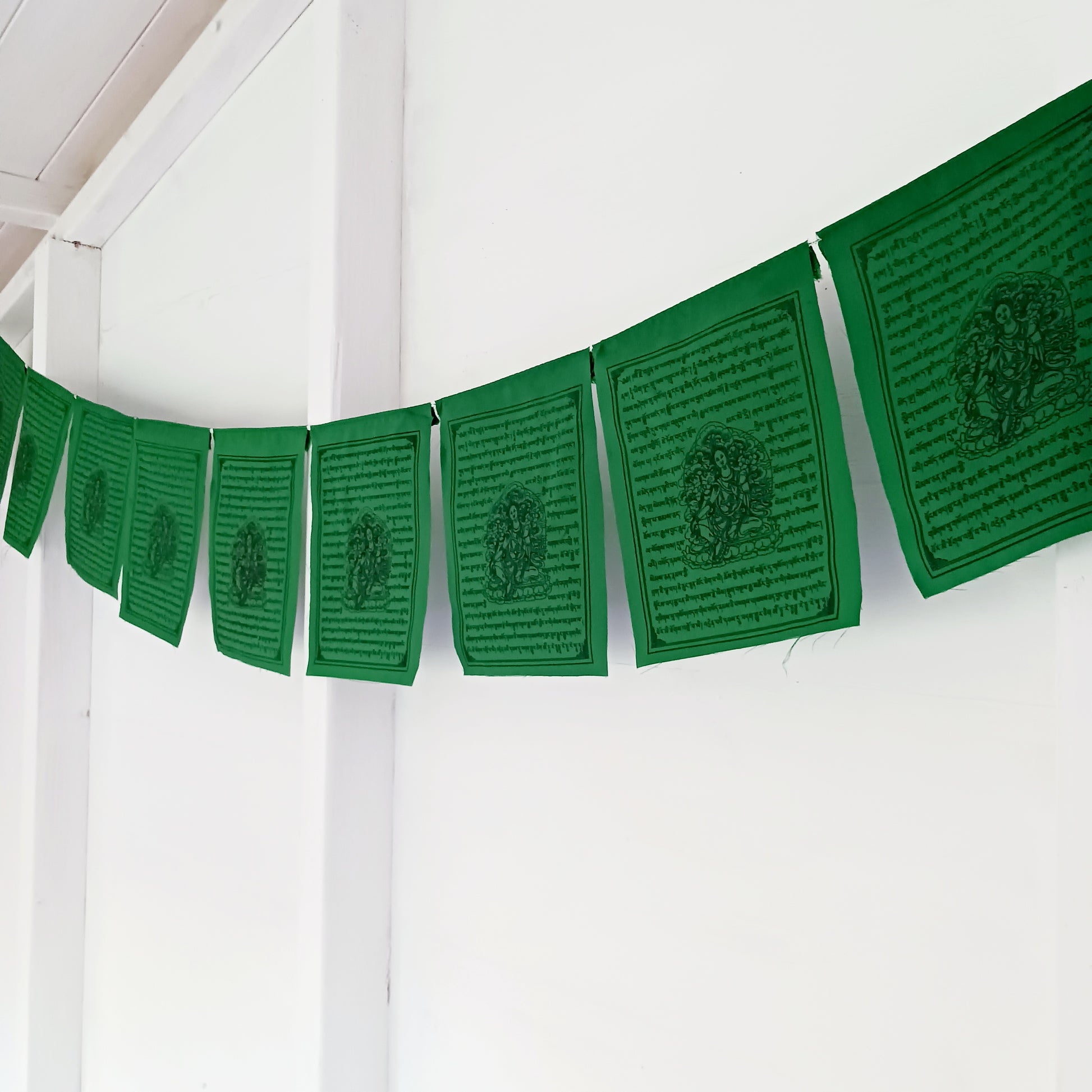 Invite the blessings of Green Tara, the Bodhisattva of Salvation, into your home or sacred space with this vibrant string of 10 prayer flags. Known for her swift and compassionate energy, Green Tara helps release fears, overcome challenges, achieve goals, and protect against negative influences.