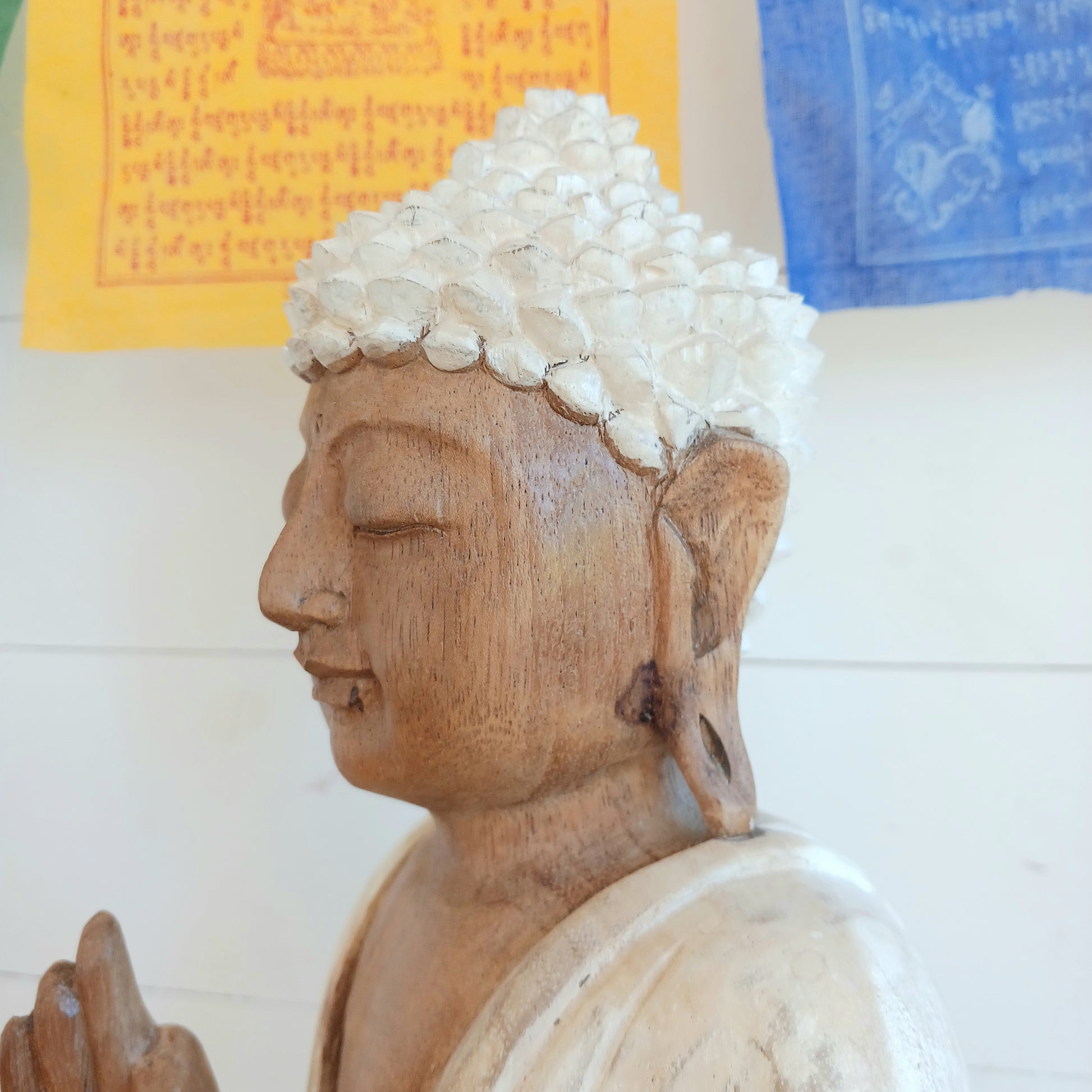 Bring calm, wisdom, and mindful intention into your space with this beautifully serene Teaching Buddha statue, hand-carved from sustainable Suar wood (Albizia Saman), a fast-growing and responsibly cultivated hardwood, finished in whitewash.