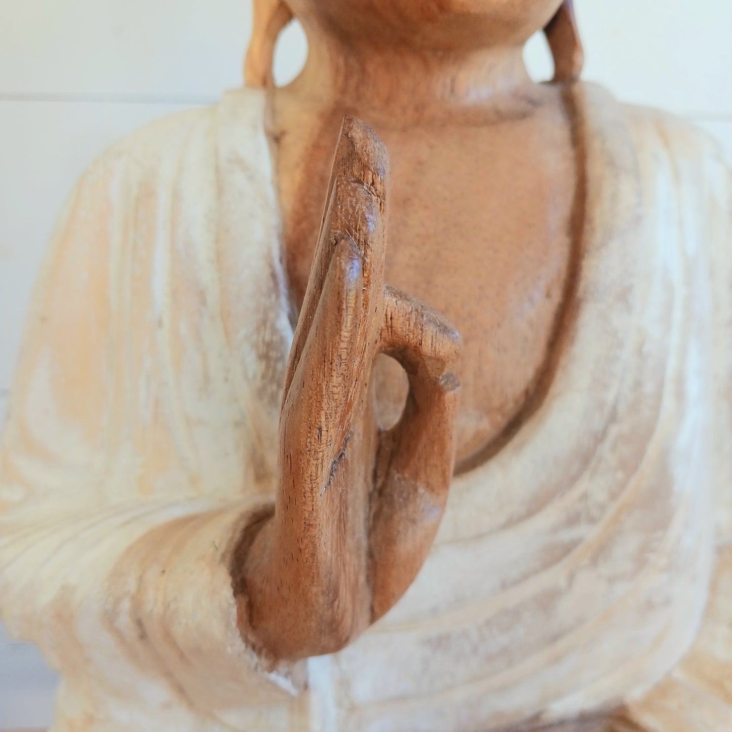 Bring calm, wisdom, and mindful intention into your space with this beautifully serene Teaching Buddha statue, hand-carved from sustainable Suar wood (Albizia Saman), a fast-growing and responsibly cultivated hardwood, finished in whitewash.