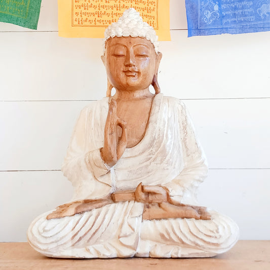 Bring calm, wisdom, and mindful intention into your space with this beautifully serene Teaching Buddha statue, hand-carved from sustainable Suar wood (Albizia Saman), a fast-growing and responsibly cultivated hardwood, finished in whitewash.