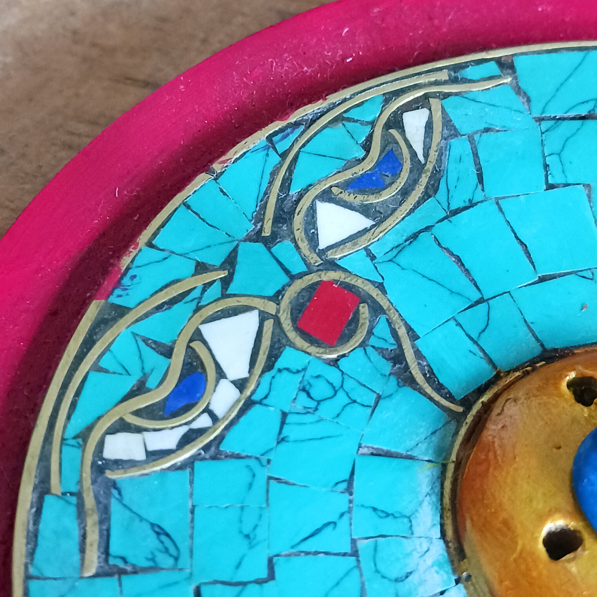 Bring a sense of peace and sacred beauty to your space with this handcrafted Tibetan Incense Holder featuring the iconic Buddha Eye design. Skilfully adorned with turquoise stone chip inlay, each piece carries a touch of Himalayan artistry and spiritual symbolism.