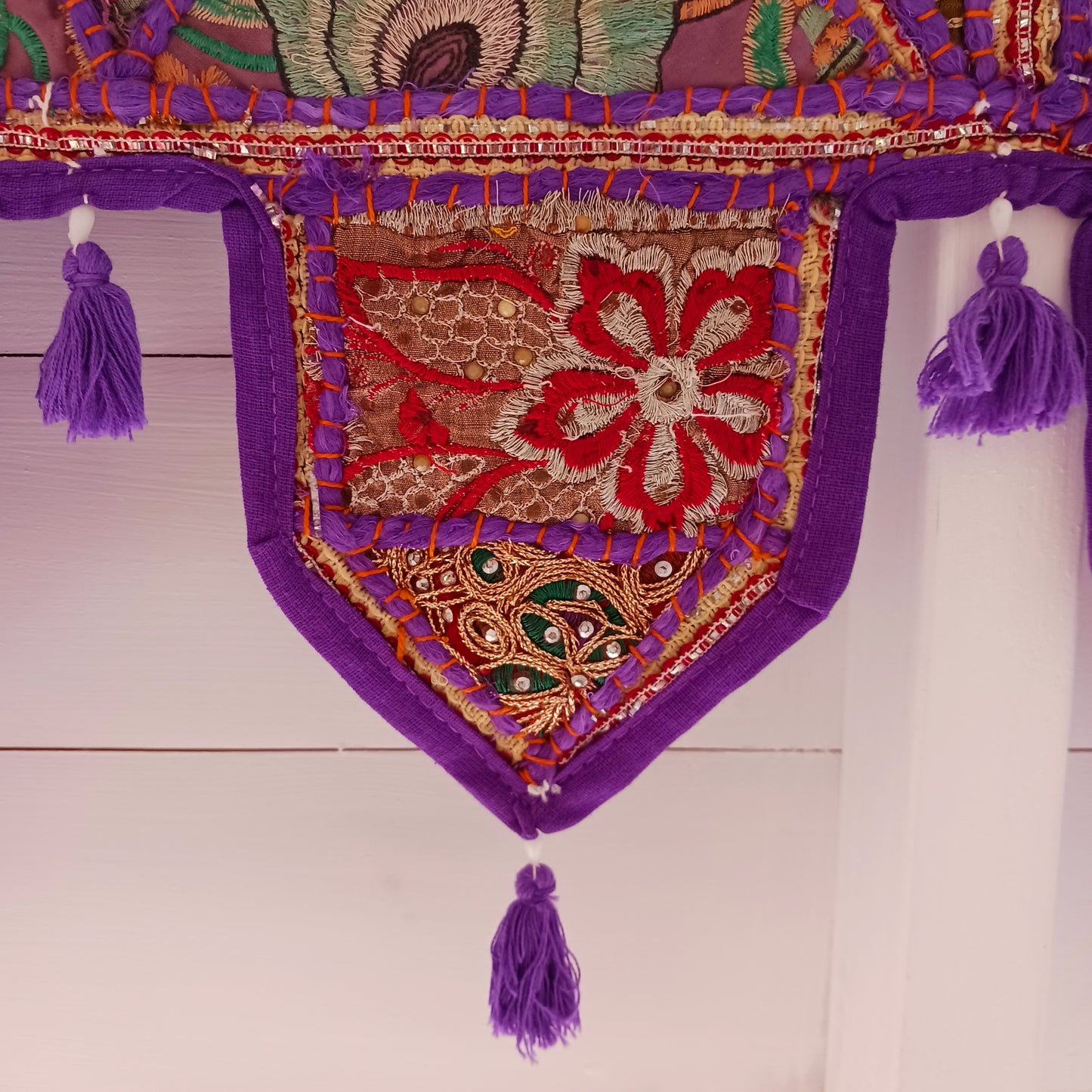 This long and beautifully intricate Indian Toran has been handmade from patches of vintage fabrics, wedding saris and recycled fabrics. It will be a unique addition to any home and bring vibrancy of colour and embellishment.