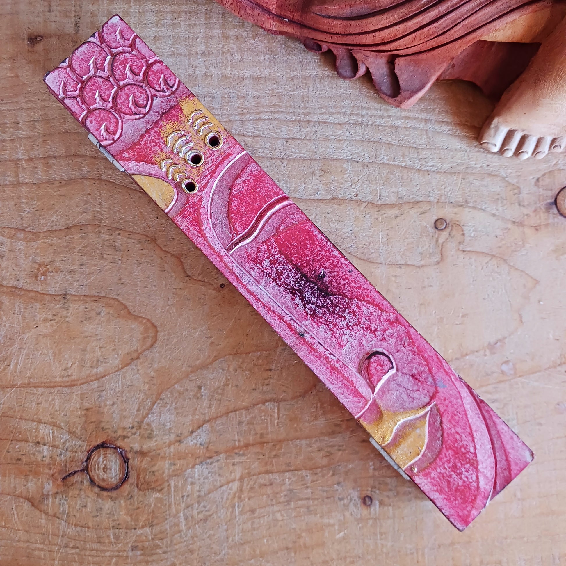 Create a calm, aromatic atmosphere in your home with this beautifully handcrafted Buddha incense holder. Made from responsibly sourced wood, this unique piece features a delicately hand-carved Buddha head, making it both a functional incense burner and a decorative spiritual accent.