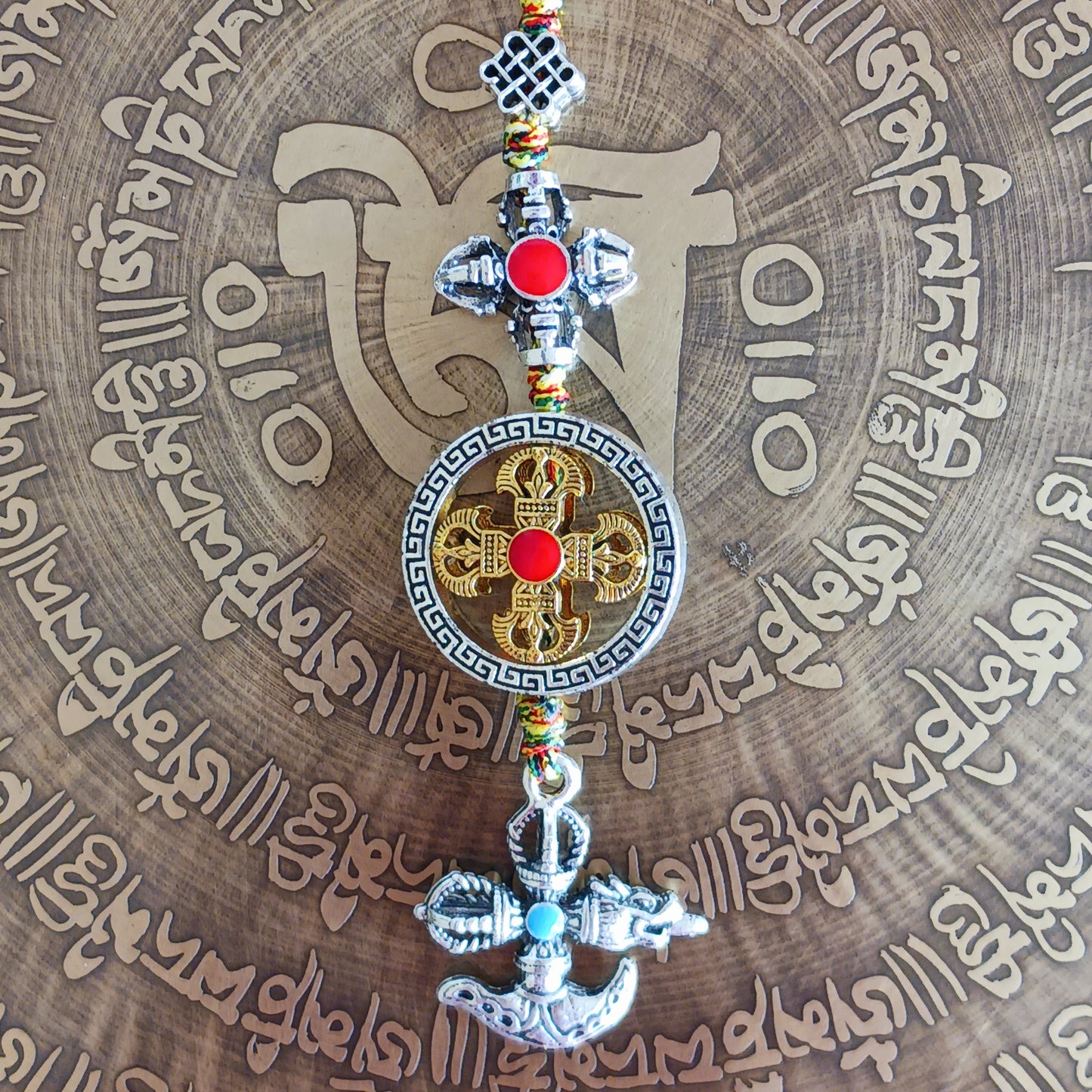Bring the power of ancient Tibetan symbolism into your daily life with this handcrafted Buddhist protective pendant. Featuring the Double Dorje, a symbol of unwavering stability and protection from fear, and the Kartika, a ritual blade representing the cutting away of ignorance and attachment, this versatile charm can be hung in your car, placed in your home, or attached to your bag or key ring