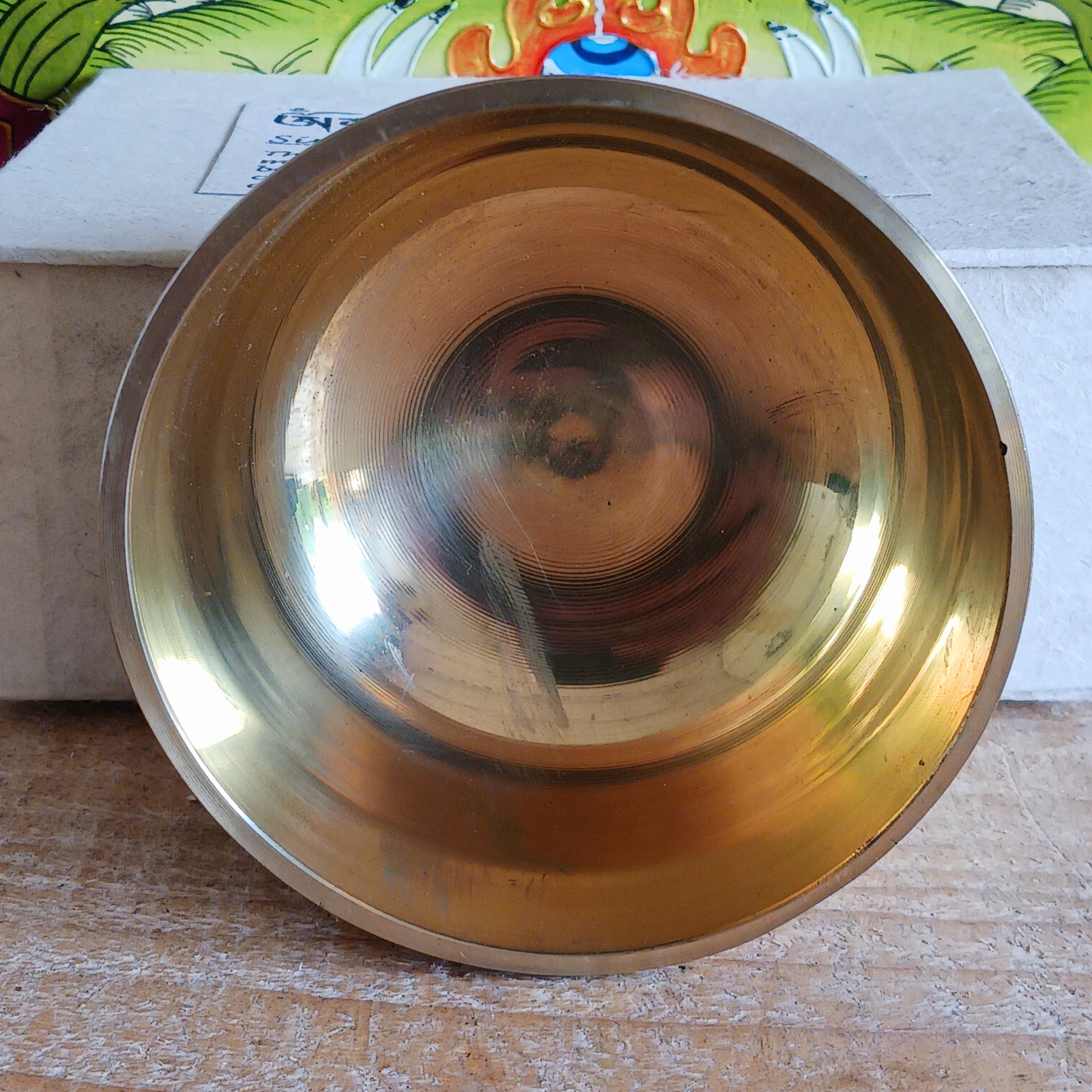 Discover the calming sound of mindfulness with this beautifully crafted Singing Bowl Gift Set. Ideal for beginners and children, the set includes a smooth, machine-made brass singing bowl that is easy to play, a wooden striker, and a soft cushion—all elegantly presented in a handmade Himalayan Lokta paper box.