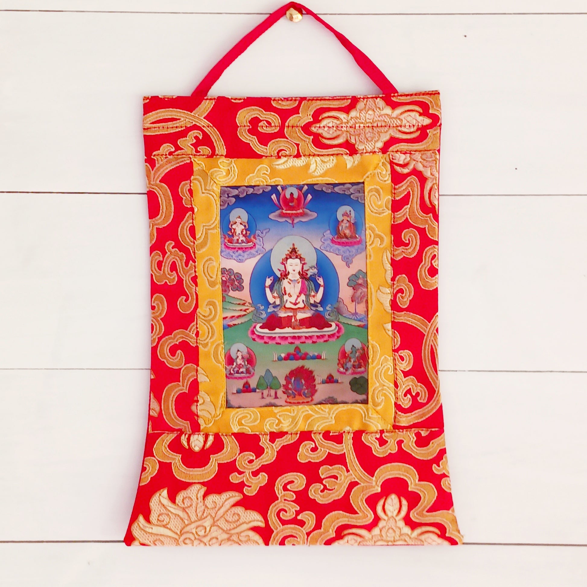 Shop this small Chenrezig thangka with silk brocade frame – a sacred image of Avalokiteshvara, the Bodhisattva of Compassion. Perfect for altars or gifting.