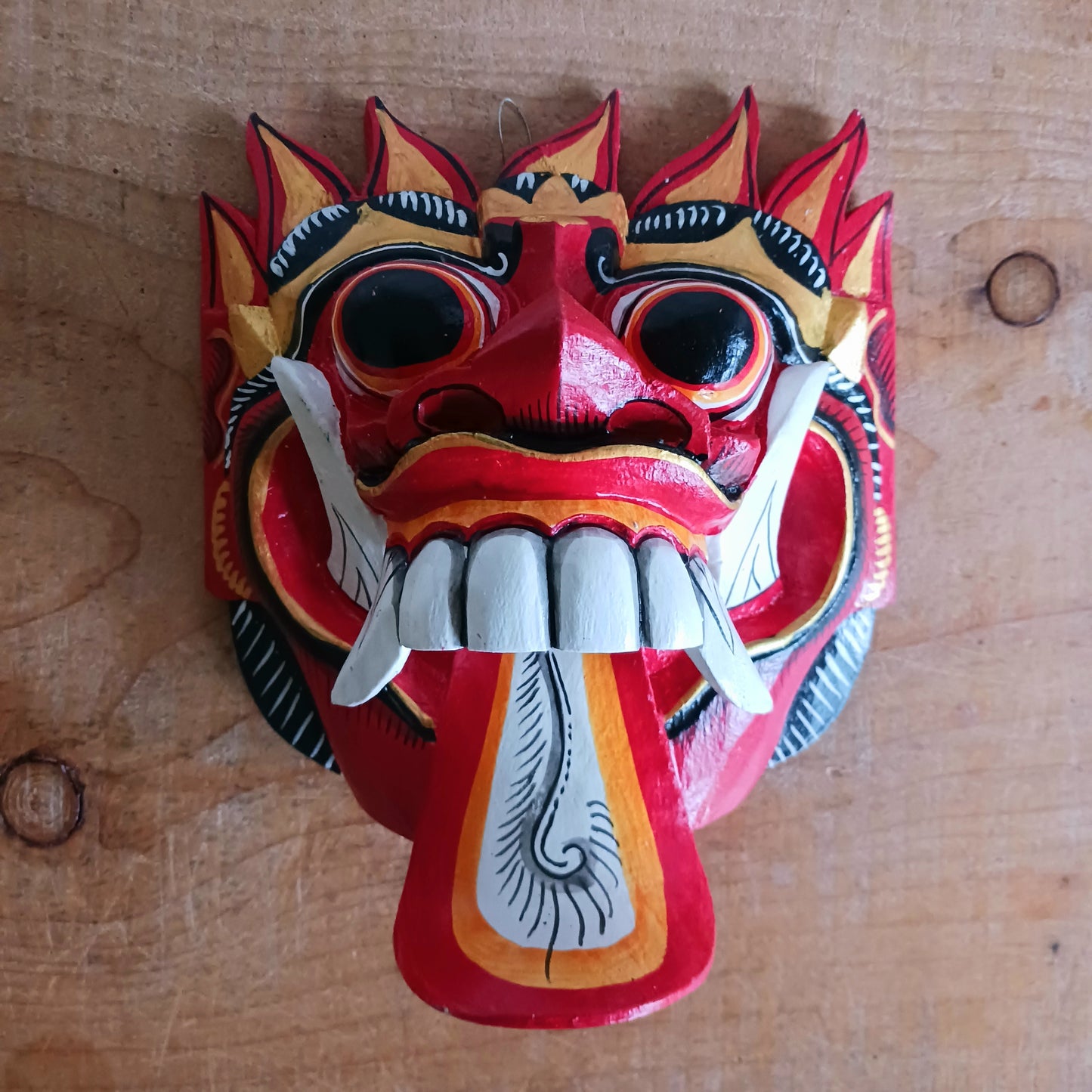 The Rangda mask is a traditional Balinese mask seen in the Barong dance. The mask depicts Rangda who is the queen of witches and represents the personification of all evil. She is depicted with a grosteque visage with protuding fangs, wild goggle eyes and long tongue. In the dance, she leads a terrifying army of witches against the forces of good and their leader, Barong.
