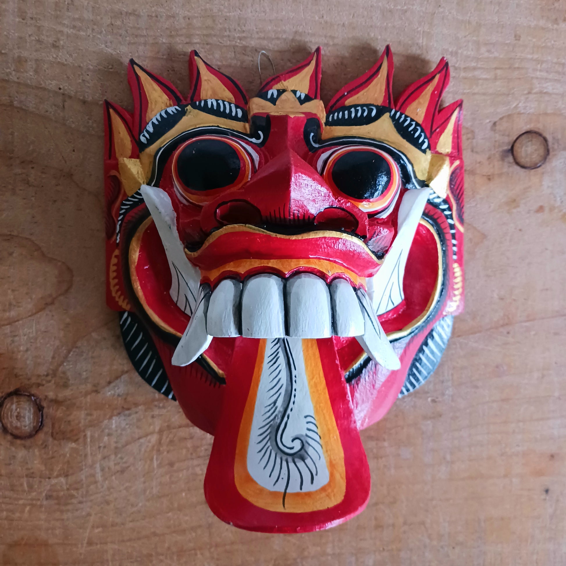 The Rangda mask is a traditional Balinese mask seen in the Barong dance. The mask depicts Rangda who is the queen of witches and represents the personification of all evil. She is depicted with a grosteque visage with protuding fangs, wild goggle eyes and long tongue. In the dance, she leads a terrifying army of witches against the forces of good and their leader, Barong.