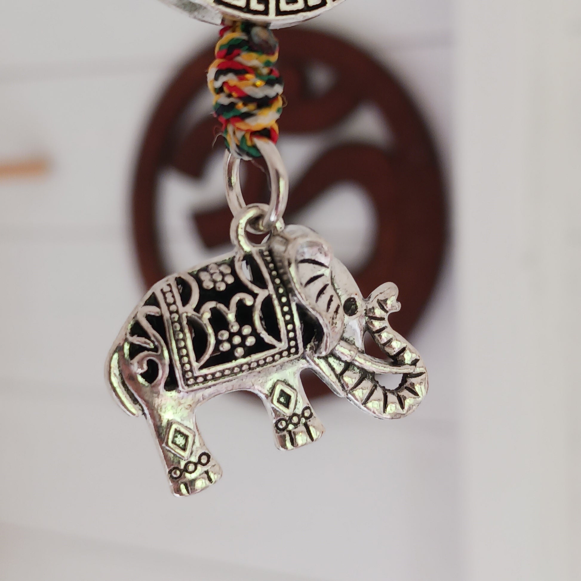 Bring peace, protection, and powerful symbolism wherever you go with this Buddhist protective pendant. Featuring the Double Dorje, a sacred symbol of stability, strength, and protection from fear, and an Elephant, representing the transformation of desire into mindfulness and contentment, this pendant is a meaningful accessory for your car, home, bag, or key ring. Crafted with intention, it's a perfect reminder of your inner strength and spiritual focus.