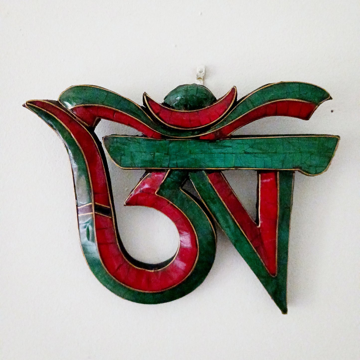 Bring harmony, artistry, and spiritual presence into your space with this handmade wooden Tibetan OM sign, inspired by the first character of the sacred mantra “Om Mani Padme Hum.”