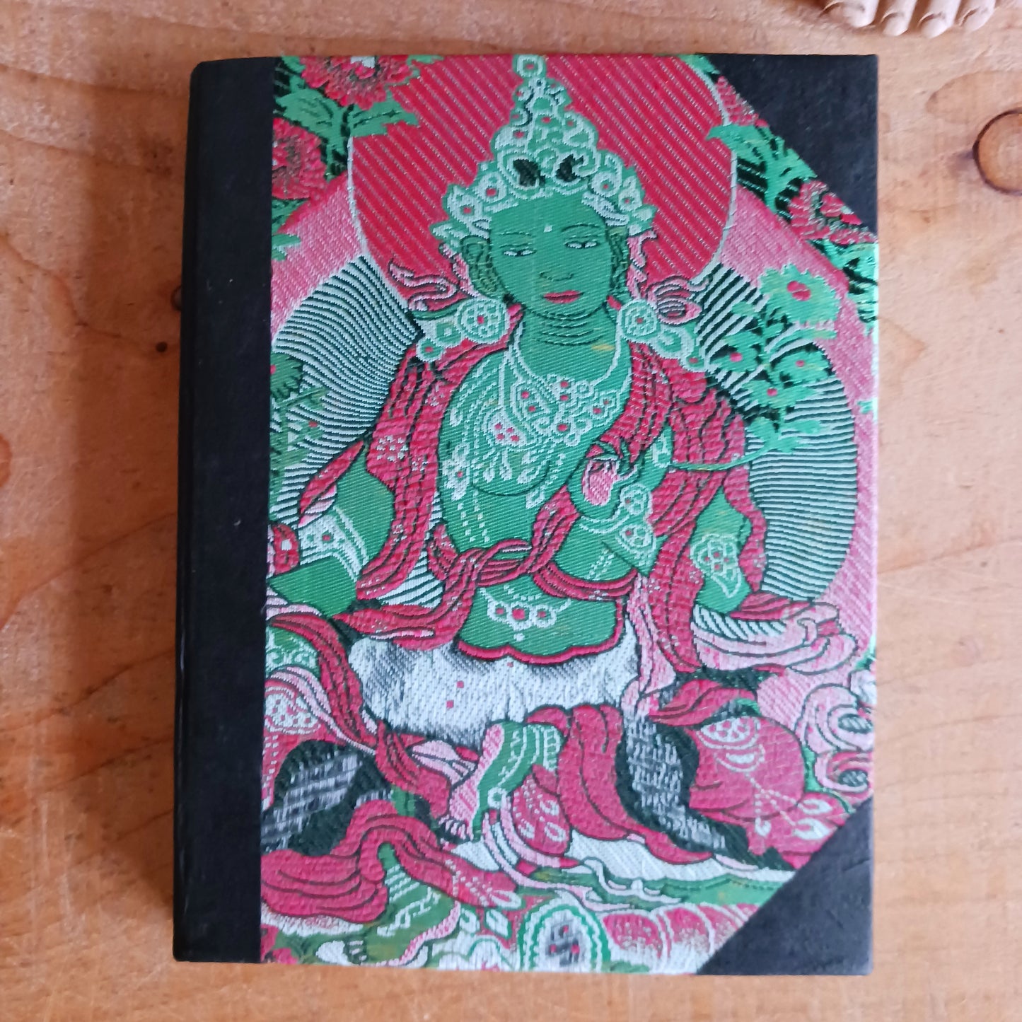 These brocade Green Tara Lokta Notebooks have been made using handmade Nepal paper and are bound with a cover of Brocade with Green Tara. They contain 50 pages made of "Lokta" paper and measure 6" x 8". The "Lokta" paper is made of Daphne Paper. It is hand made using a traditional method without involving any mechanical equipment, and no chemicals are used.