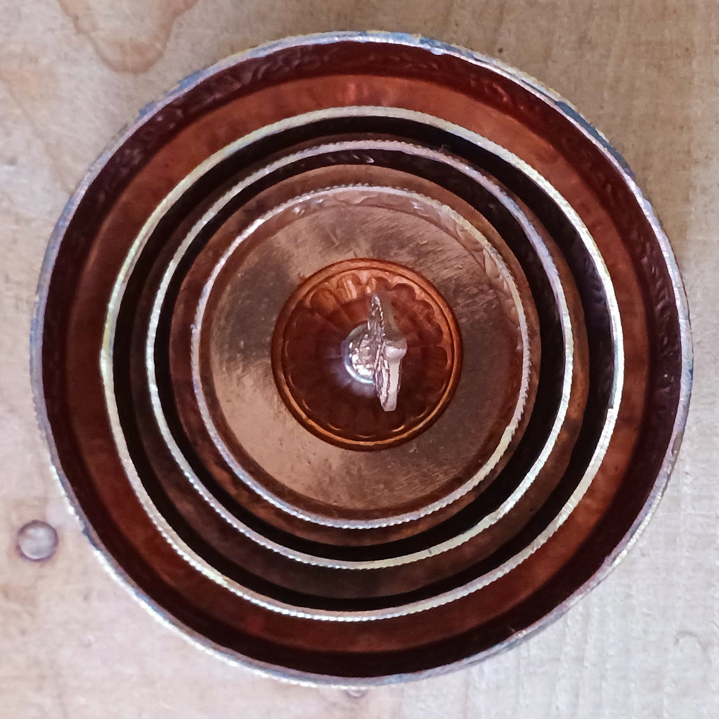 Elevate your spiritual practice with this handmade large copper mandala offering set, crafted with traditional Tibetan artistry. In Tibetan Buddhism, offering a mandala symbolizes offering the entire universe—mountains, continents, precious substances, and realms—to the enlightened beings. Through this profound practice, one accumulates merit, wisdom, and spiritual clarity.