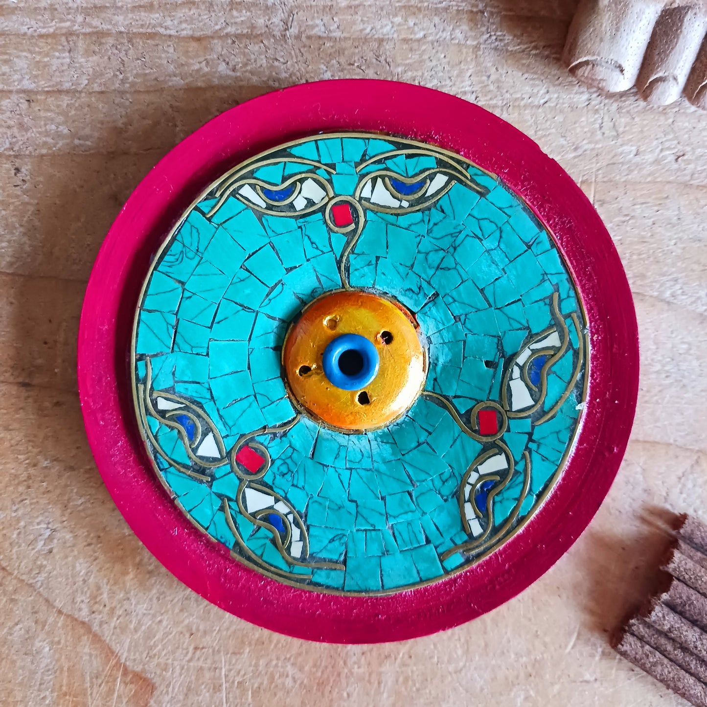 Bring a sense of peace and sacred beauty to your space with this handcrafted Tibetan Incense Holder featuring the iconic Buddha Eye design. Skilfully adorned with turquoise stone chip inlay, each piece carries a touch of Himalayan artistry and spiritual symbolism.