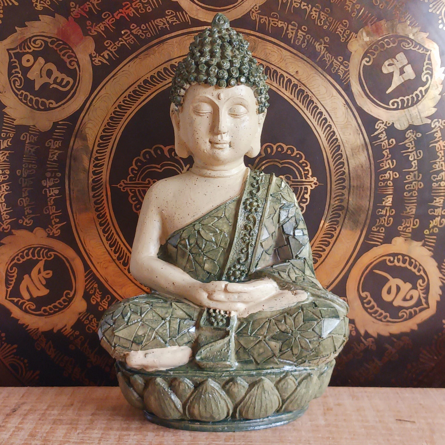 Invite peace and mindfulness into your space with this Buddha statuette, featuring a calming green mosaic pattern. Seated in the classic meditation pose with a tranquil expression, this modest figure is perfect for a shelf, home altar, or personal meditation corner. 