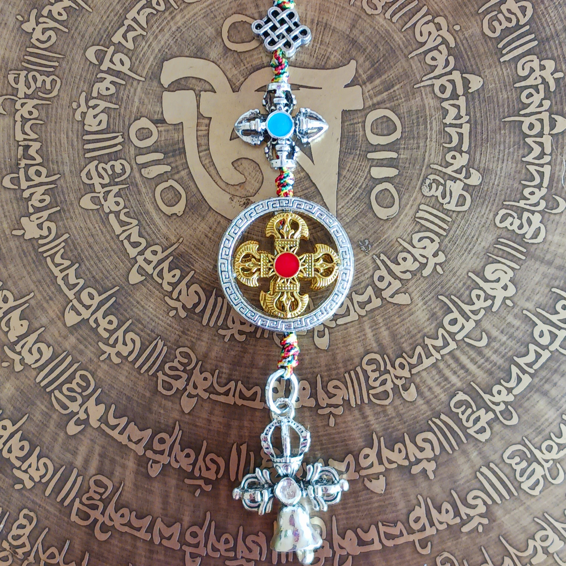 Bring peace, protection, and wisdom wherever you go with this handcrafted Buddhist protective pendant. Featuring the powerful Double Dorje, a symbol of stability and fearlessness, and the Bell, representing wisdom and the understanding of emptiness, this sacred charm is ideal for your car, home, bag, or key ring. Whether you're seeking spiritual grounding or a meaningful gift, this pendant serves as a constant reminder of balance and enlightenment in daily life.