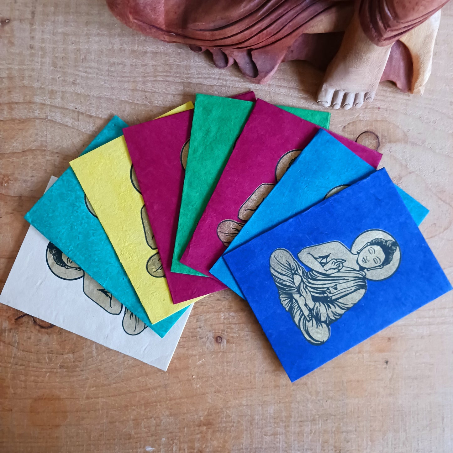 Share peace, colour, and meaningful craftsmanship with this beautifully decorated Buddha greeting card set, handmade from traditional Lokta paper. Sourced from the high-altitude Himalayan forests of Nepal, Lokta paper has been crafted for centuries using sustainable methods. The fast-growing Lokta bush regenerates quickly, making it an eco-friendly alternative to conventional paper.