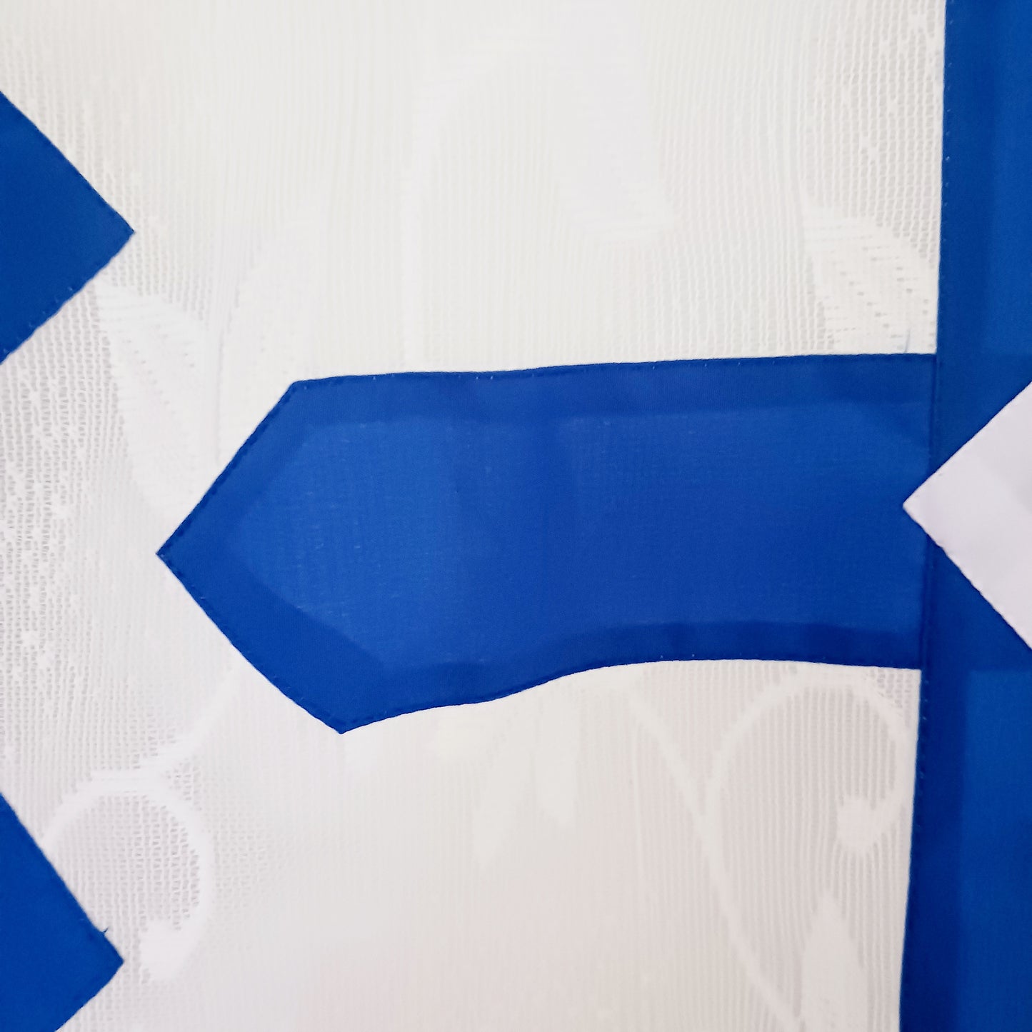 Bring spiritual harmony and traditional Himalayan craftsmanship into your home with this handmade Tibetan Buddhist Endless Knot Door Curtain. Crafted in a white fabric, this semi-transparent curtain allows natural light to pass through, creating a warm and calming atmosphere.