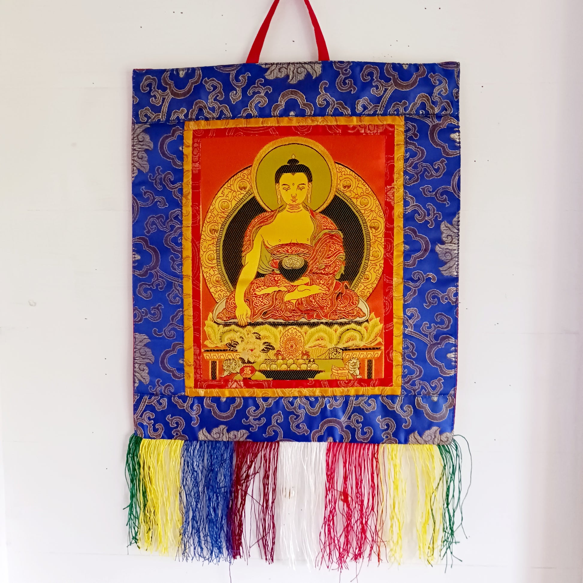 Bring serenity, beauty, and spiritual inspiration into any space with this Handmade Embroidered Buddha Thangka, crafted by skilled artisans in Nepal. Each piece is created using traditional techniques passed down through generations, featuring intricate embroidery and a rich brocade border that highlights the calm and compassionate presence of the Buddha.