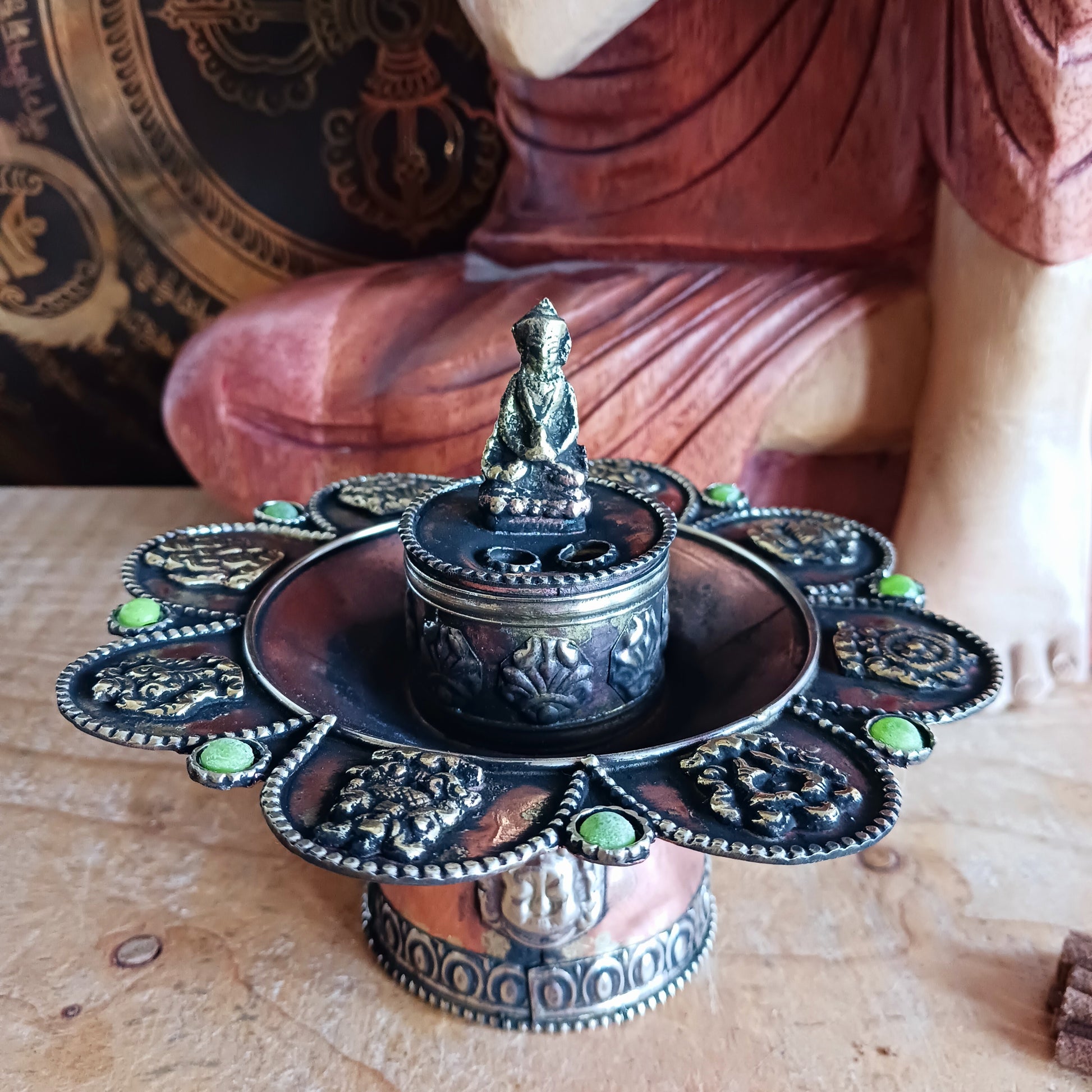 Bring harmony, tradition, and beauty into your sacred space with this handcrafted Round Copper Tibetan Incense Burner. Designed with intricate Auspicious Symbols and decorated with a Buddha and imitation green stone inlays, this burner serves both as a functional ritual tool and a stunning decorative piece.