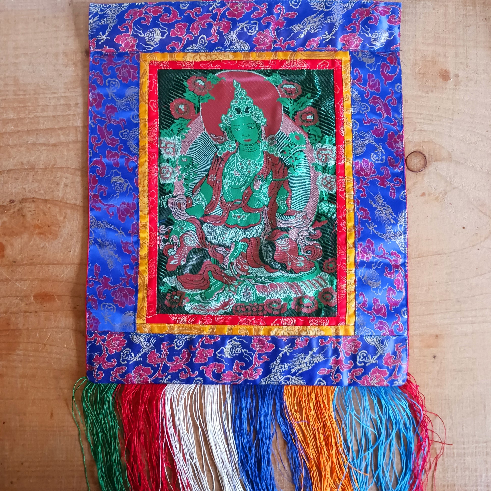 Bring serenity, beauty, and spiritual inspiration into any space with this Handmade Embroidered Green Tara Thangka, crafted by skilled artisans in Nepal. Each piece is created using traditional techniques passed down through generations, featuring intricate embroidery and a rich brocade border that highlights the calm and compassionate presence of Green Tara.
