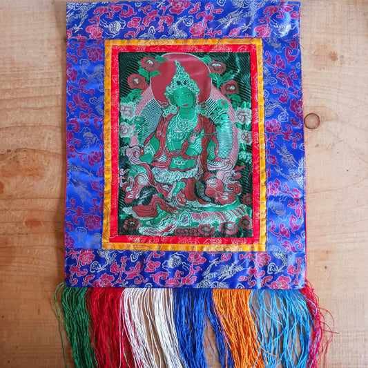 Bring serenity, beauty, and spiritual inspiration into any space with this Handmade Embroidered Green Tara Thangka, crafted by skilled artisans in Nepal. Each piece is created using traditional techniques passed down through generations, featuring intricate embroidery and a rich brocade border that highlights the calm and compassionate presence of Green Tara.