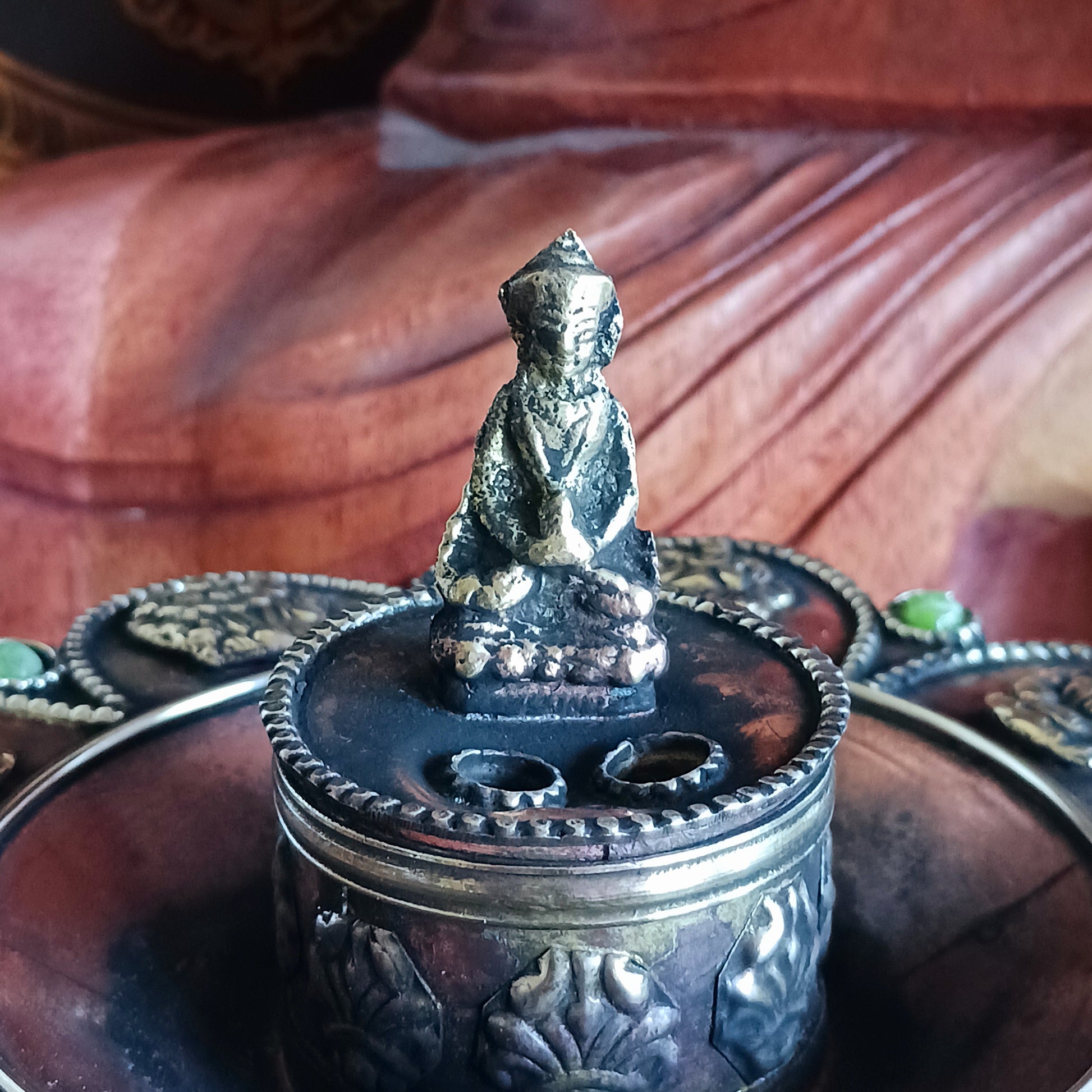 Bring harmony, tradition, and beauty into your sacred space with this handcrafted Round Copper Tibetan Incense Burner. Designed with intricate Auspicious Symbols and decorated with a Buddha and imitation green stone inlays, this burner serves both as a functional ritual tool and a stunning decorative piece.