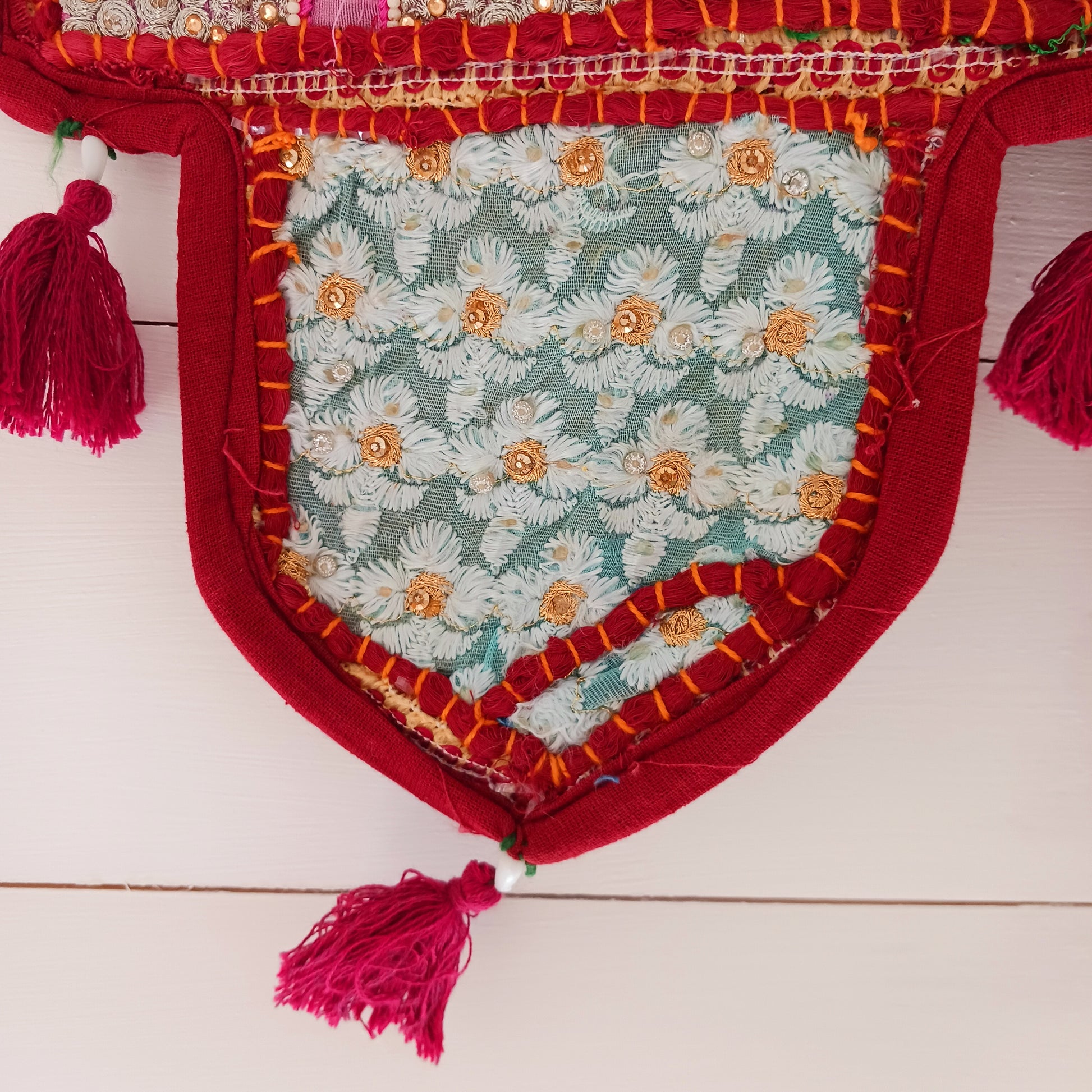 This long and beautifully intricate Indian Toran has been handmade from patches of vintage fabrics, wedding saris and recycled fabrics.  It will be a unique addition to any home and bring vibrancy of colour and embellishment.