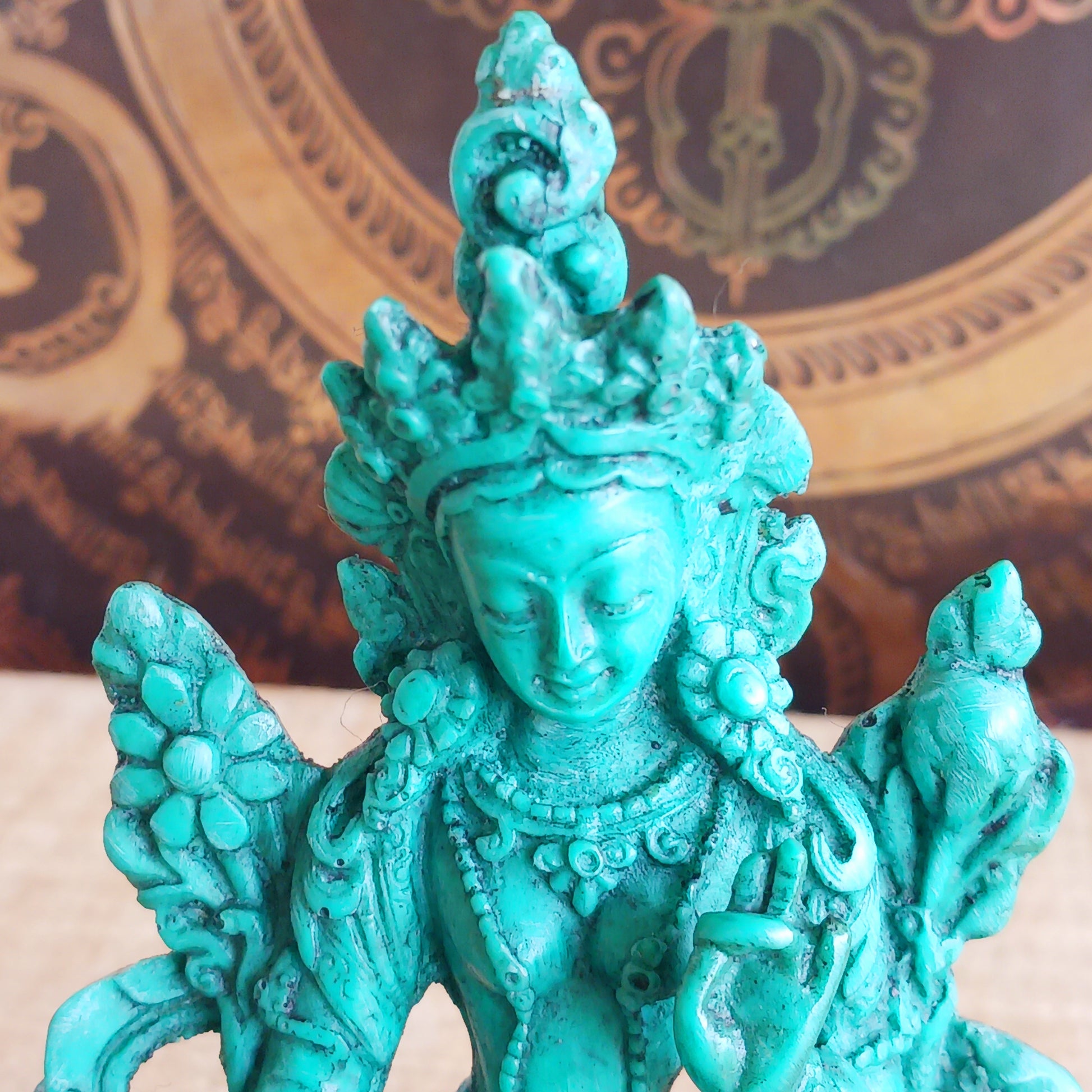 This beautiful and bold green resin statue depicts Green Tara, the revered Buddhist goddess of compassion, protection, and swift action.