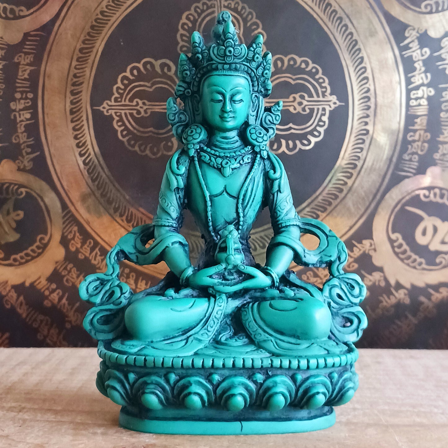 White Tara is known for compassion, long life, healing and serenity and is shown here with her right hand in the varada mudra (blessing pose.) White Tara is distinct from the more commonly seen Green Tara. She is seated in a tranquil, full lotus position as opposed to Green Tara's one foot extended pose. These intricate resin statues are carefully handcrafted in Nepal.