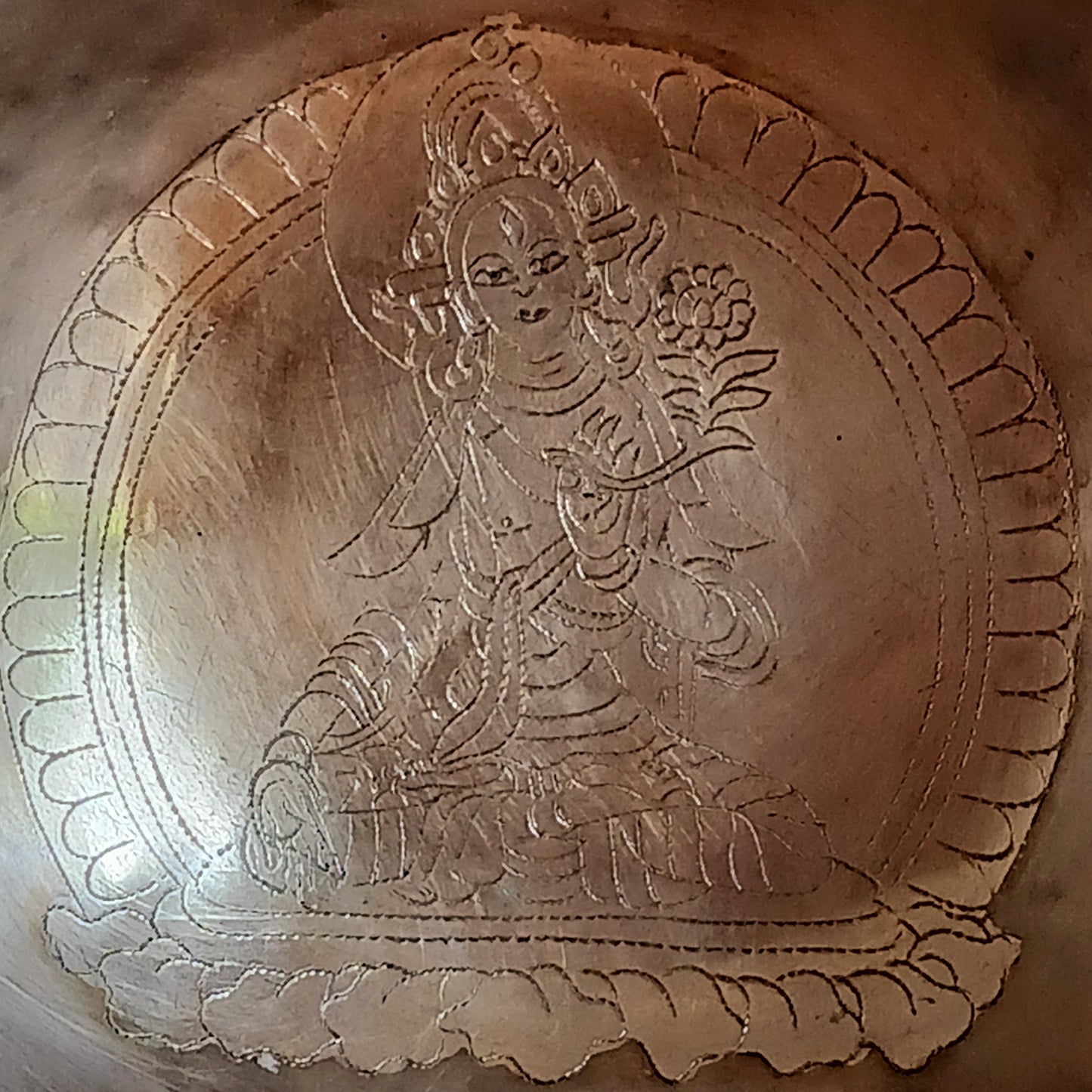 Elevate your spiritual practice with this unique, hand-beaten singing bowl, featuring a stunning Green Tara engraving inside the bowl. Known as the goddess of compassion and action, Green Tara is a powerful symbol in Tibetan Buddhism, bringing calm, protection, and clarity to your space. This bowl produces rich, resonant tones perfect for meditation, sound healing, or sacred decor.