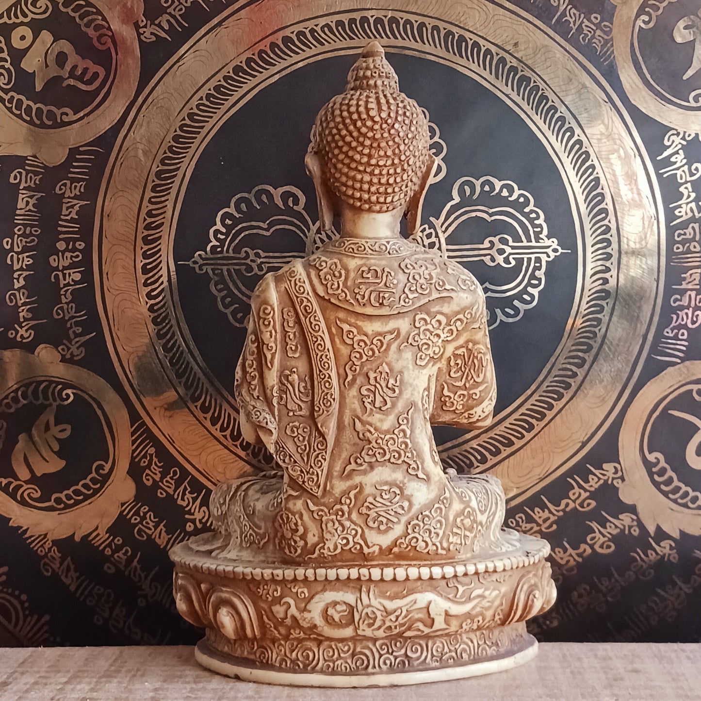 Bring serenity and wisdom into your space with this large, intricately detailed Buddha statue. Cast in a deep sand colour, this statue depicts the Buddha in the Dharmachakra Mudra — the "Wheel of Dharma" gesture. 