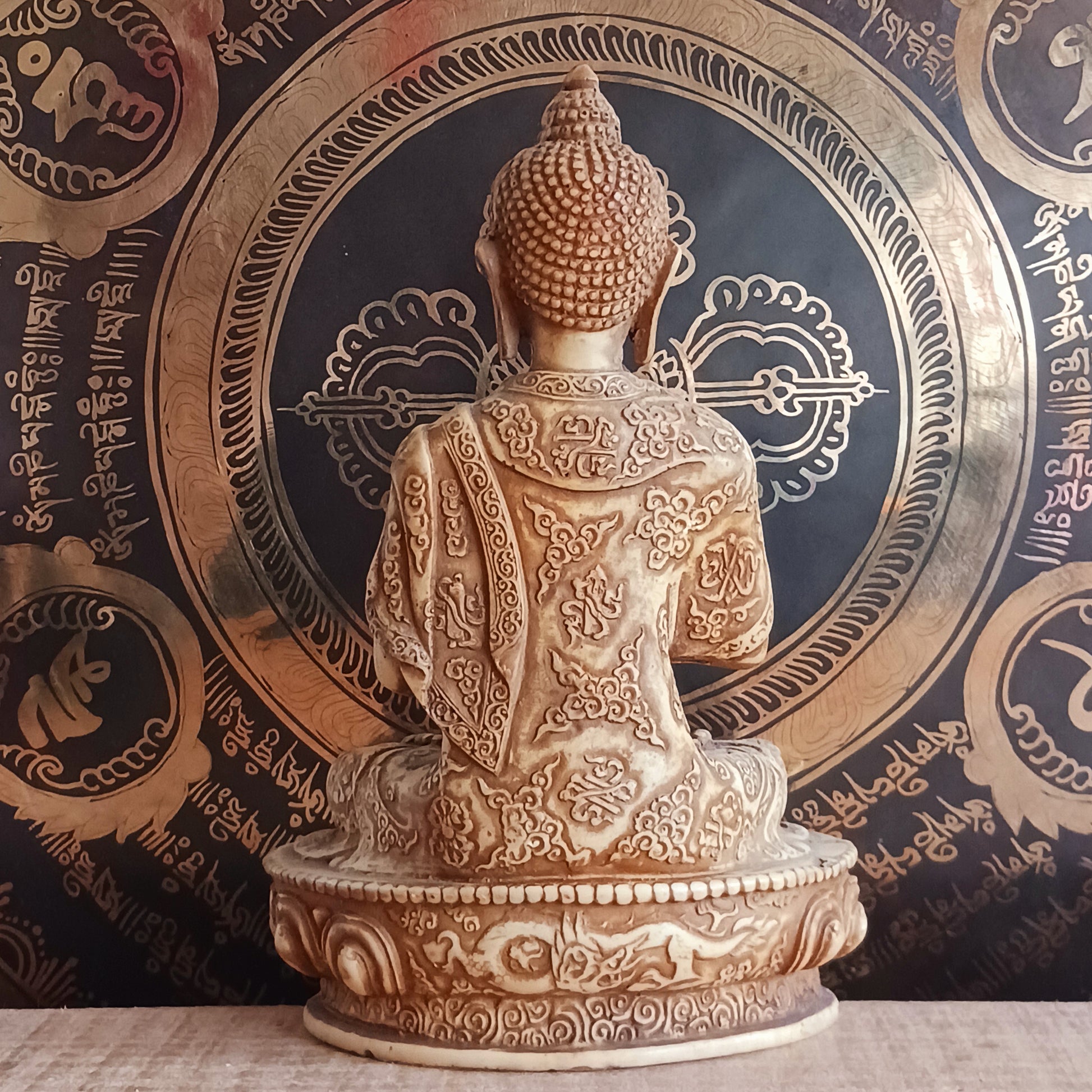 Bring serenity and wisdom into your space with this large, intricately detailed Buddha statue. Cast in a deep sand colour, this statue depicts the Buddha in the Dharmachakra Mudra — the "Wheel of Dharma" gesture. 