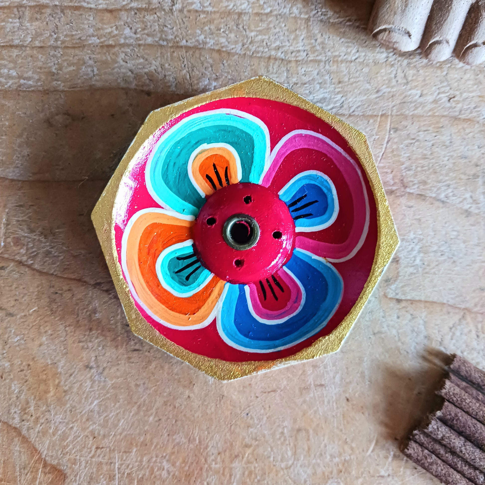 A beautiful little handcrafted Tibetan Incense stick holder, Hand painted and ethically sourced this incense holder is perfect for the larger Tibetan incense and also has 4 small holes for Indian sticks.